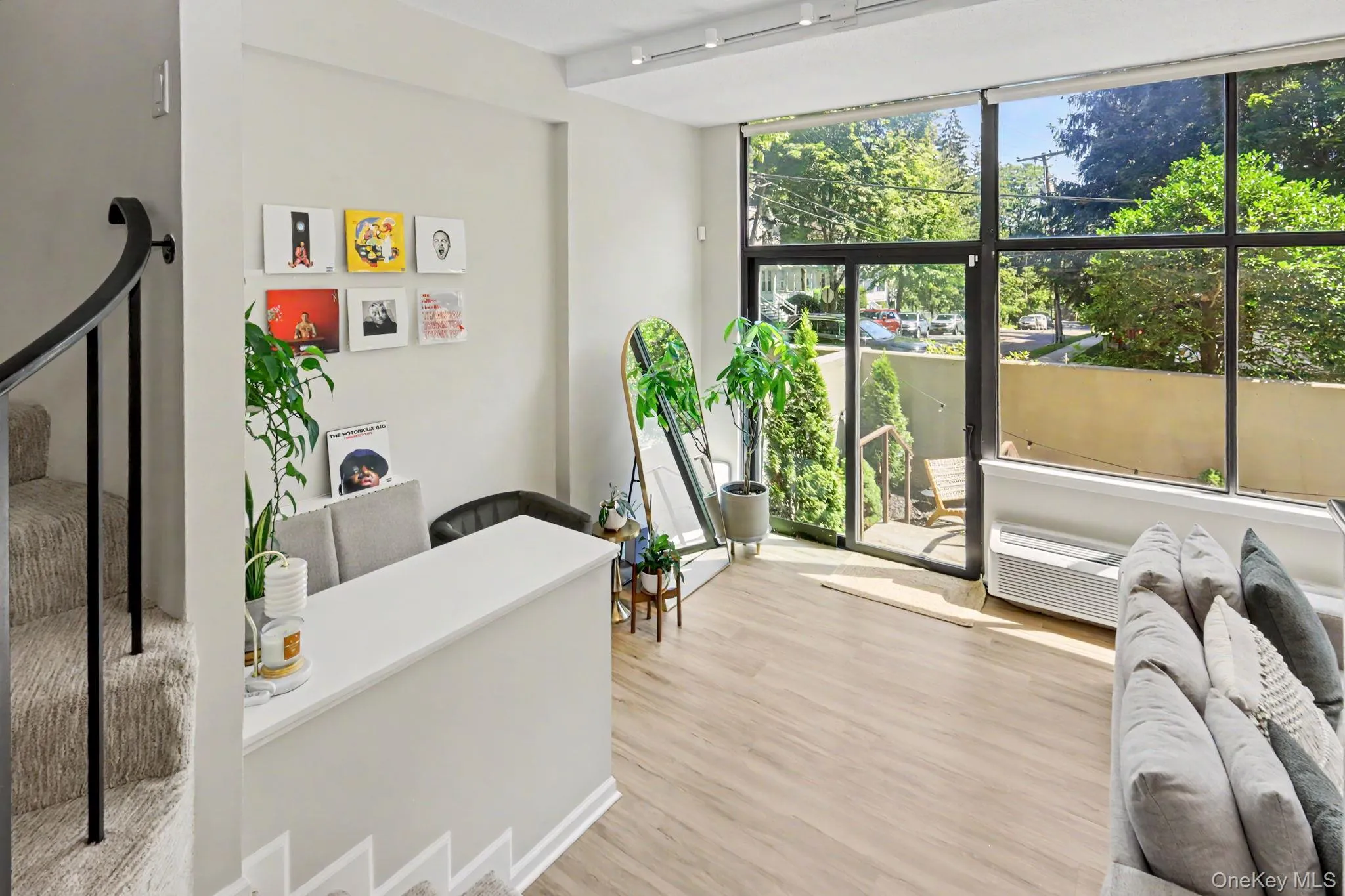Two sets of glass doors open directly to the private terrace, creating a seamless connection between indoor and outdoor living. Two sets of glass doors open directly to the private terrace, creating a seamless connection between indoor and outdoor living.