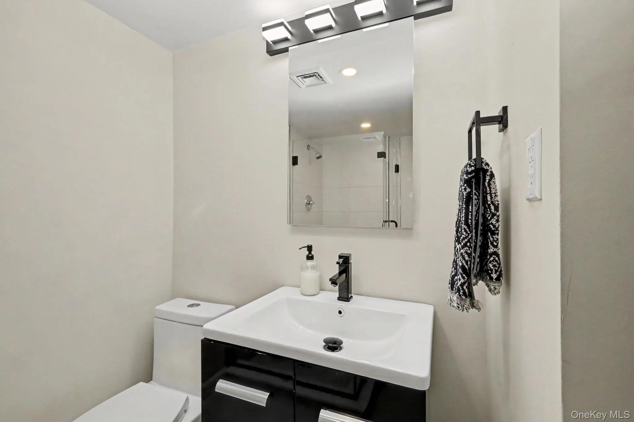 Sleek glass shower doors, designer lighting, and an elegant statement mirror, creating a polished and serene space to begin and end the day. Sleek glass shower doors, designer lighting, and an elegant statement mirror, creating a polished and serene space to begin and end the day.
