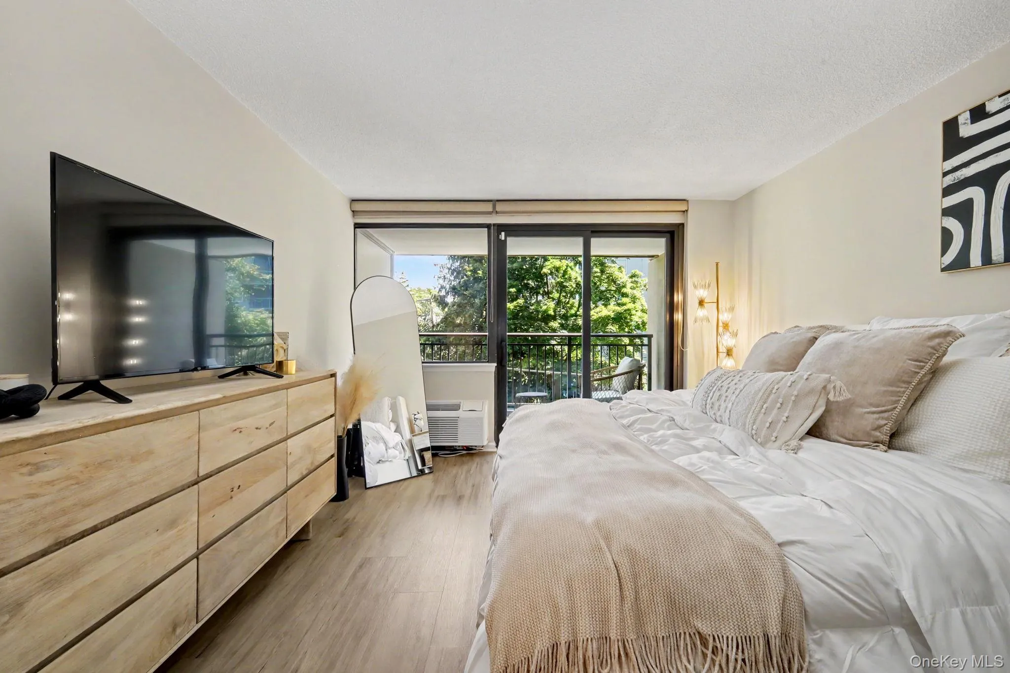 The spacious, sun-filled primary bedroom offers a serene private retreat, complete with glass doors opening to its own private balcony. The spacious, sun-filled primary bedroom offers a serene private retreat, complete with glass doors opening to its own private balcony.