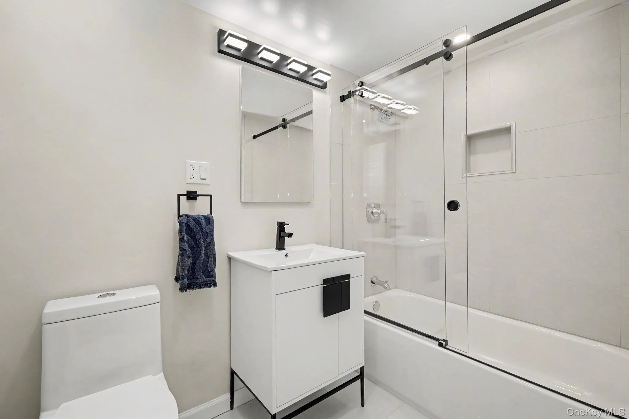 The newly renovated hall bathroom showcases thoughtfully selected designer finishes, creating a fresh, sophisticated space with a polished contemporary feel. The newly renovated hall bathroom showcases thoughtfully selected designer finishes, creating a fresh, sophisticated space with a polished contemporary feel.