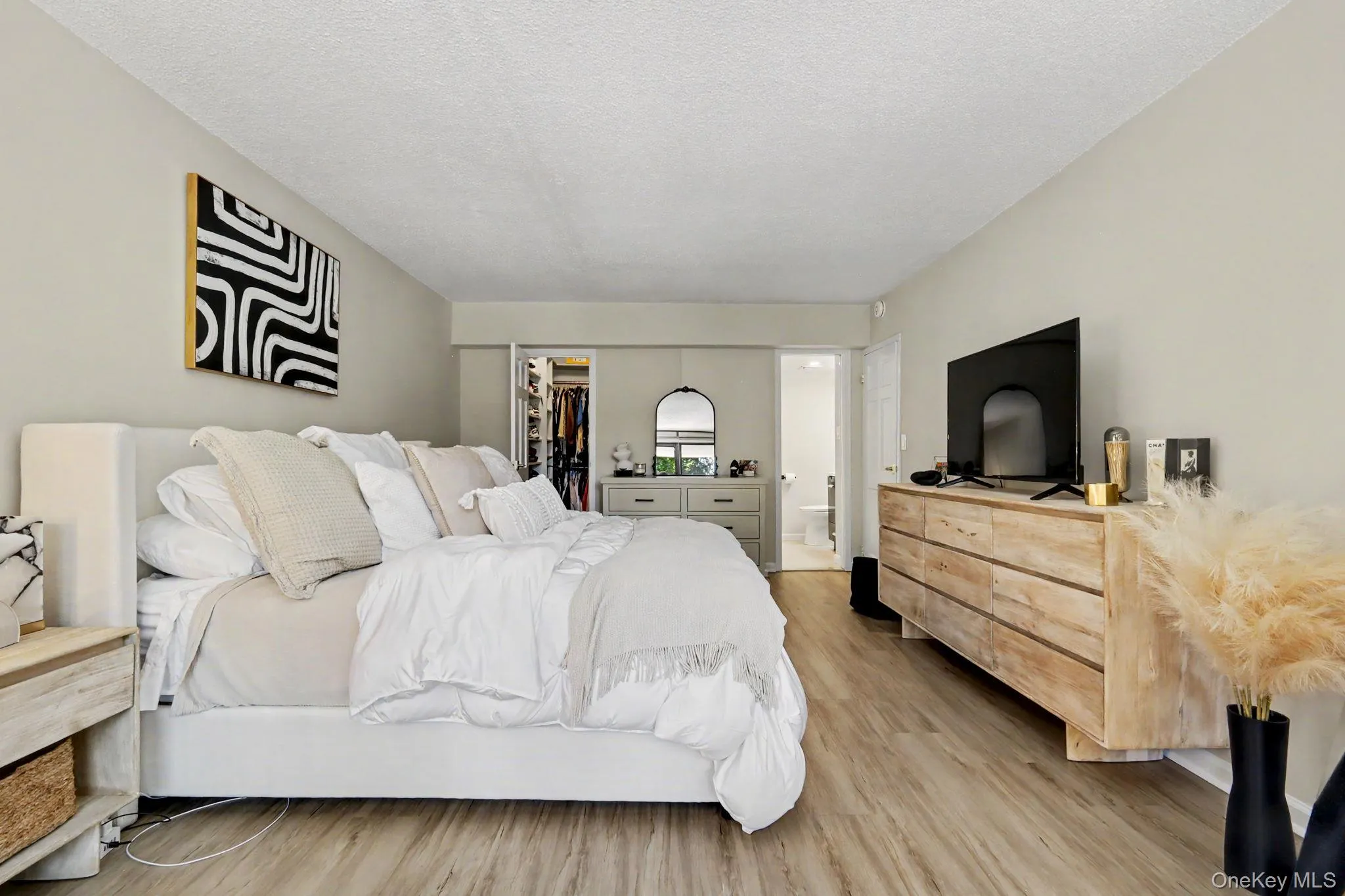 A generous walk-in closet, and beautiful flooring that adds warmth and elegance to the space. A generous walk-in closet, and beautiful flooring that adds warmth and elegance to the space.