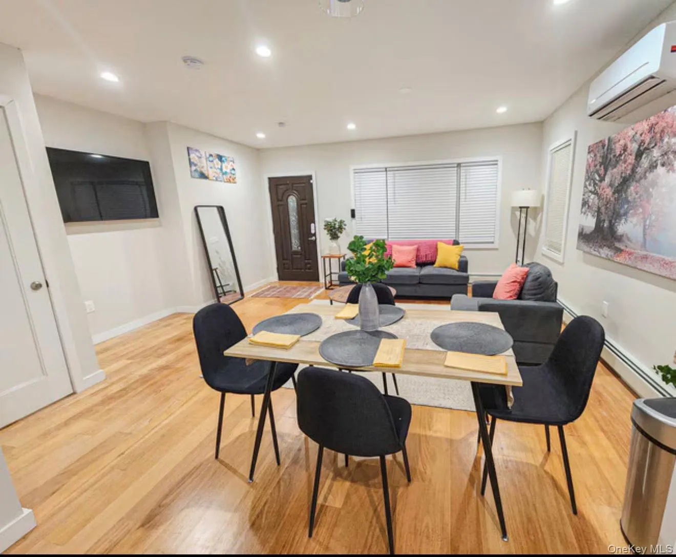 Wood-finish flooring, recessed lighting, white interior doors, and a dark-toned entry door with decorative glass paneling Wood-finish flooring, recessed lighting, white interior doors, and a dark-toned entry door with decorative glass paneling