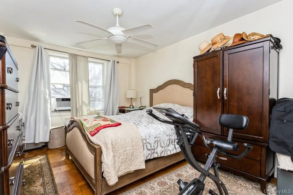 Bedroom with cooling unit and a ceiling fan Bedroom with cooling unit and a ceiling fan