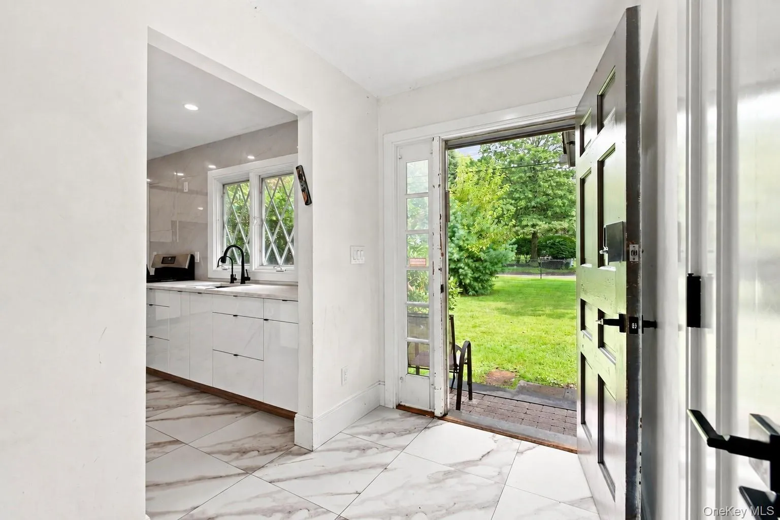 Marble-look tile flooring, entryway with dark-paneled door, Marble-look tile flooring, entryway with dark-paneled door,