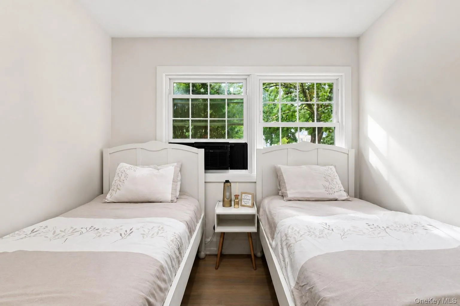 Light-toned walls, wood-finish flooring, and white trim windows Light-toned walls, wood-finish flooring, and white trim windows