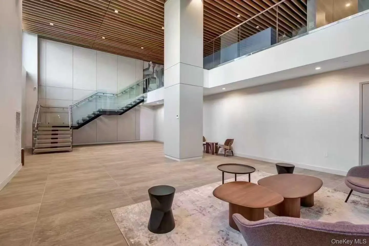 Common area featuring a towering ceiling, stairway, and recessed lighting Common area featuring a towering ceiling, stairway, and recessed lighting