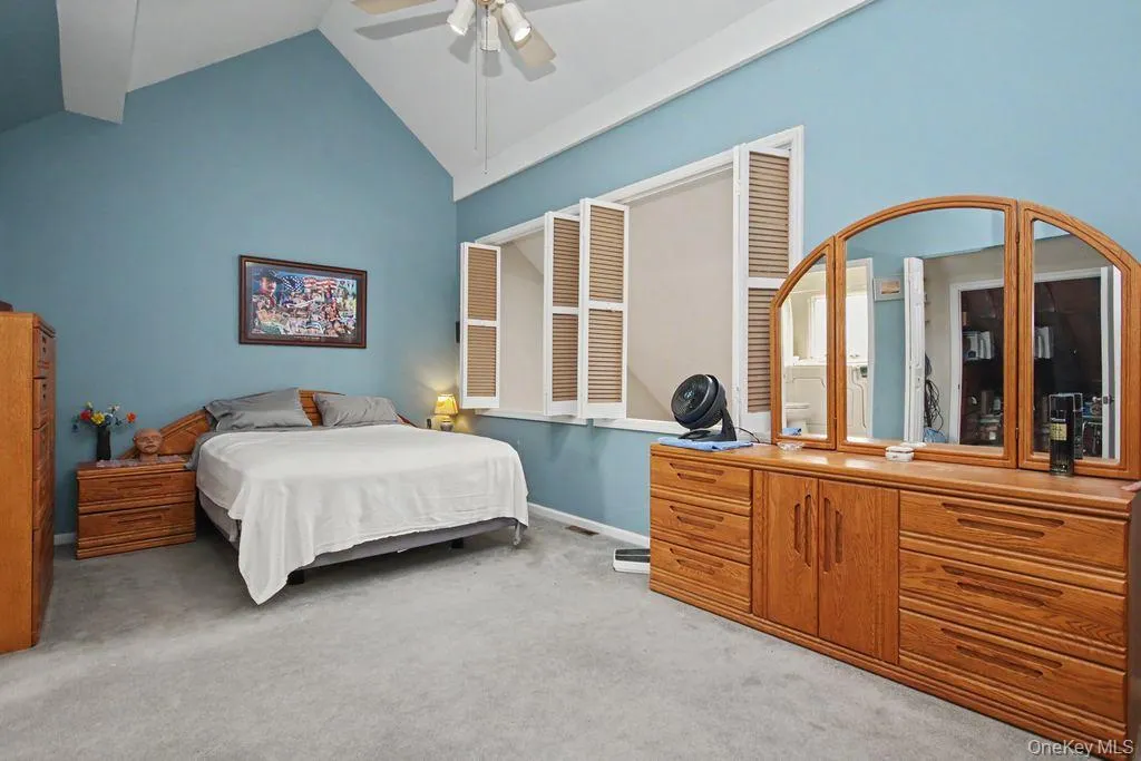 Primary Bedroom has vaulted ceilings and a ceiling fan with light Primary Bedroom has vaulted ceilings and a ceiling fan with light