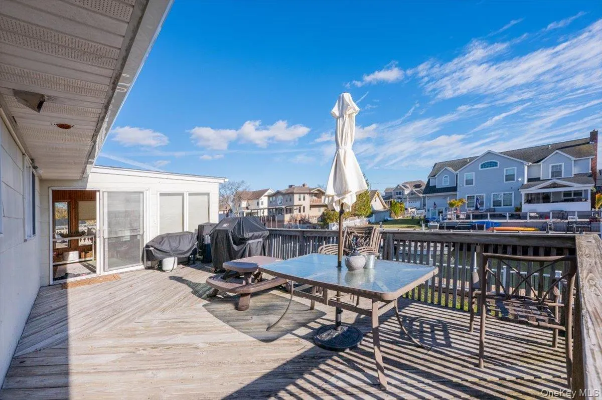 Wooden terrace featuring a grill Wooden terrace featuring a grill