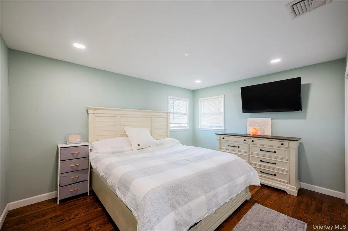 Bedroom with dark hardwood / wood-style floors Bedroom with dark hardwood / wood-style floors