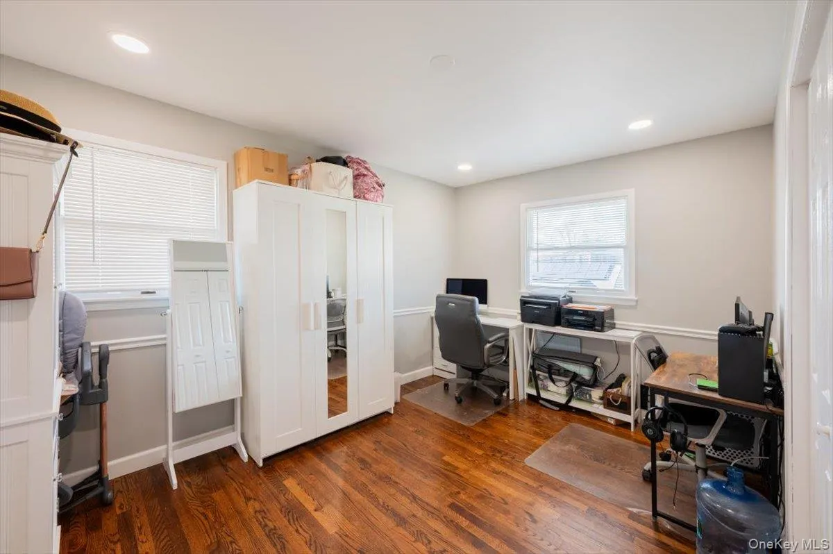 Home office featuring dark hardwood / wood-style flooring Home office featuring dark hardwood / wood-style flooring