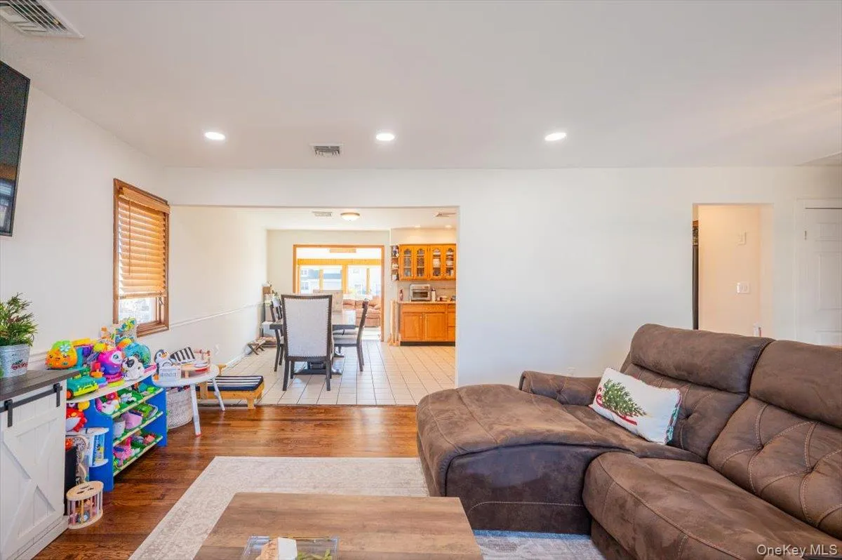 Living room featuring a wealth of natural light and hardwood / wood-style floors Living room featuring a wealth of natural light and hardwood / wood-style floors