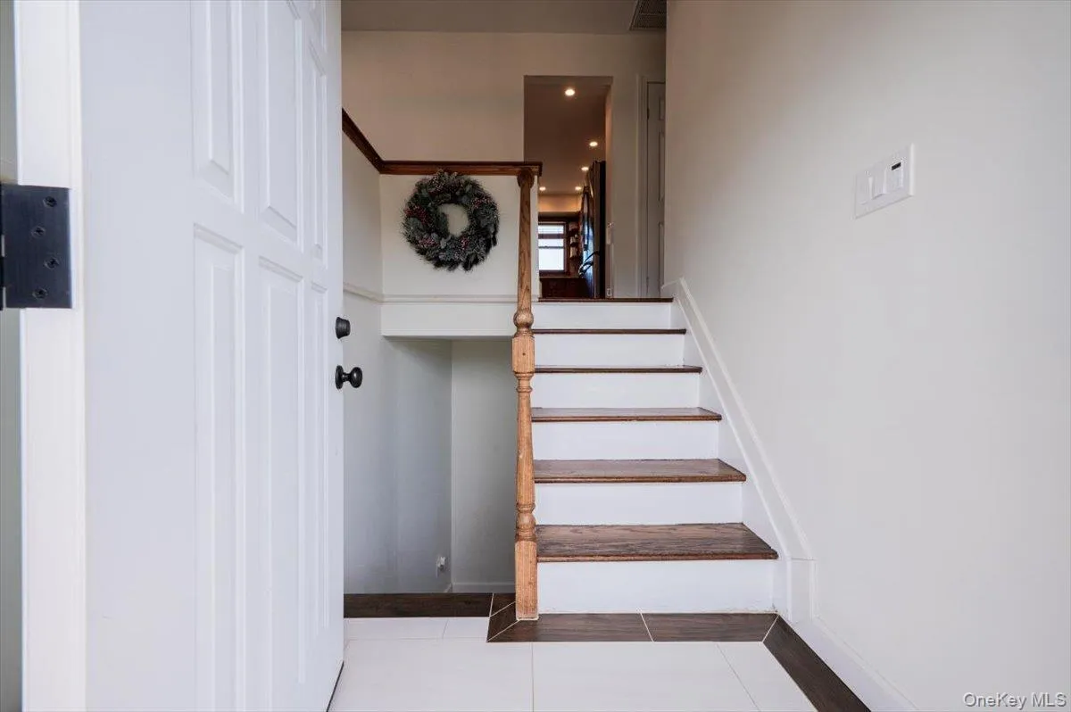 Stairway featuring tile patterned floors Stairway featuring tile patterned floors