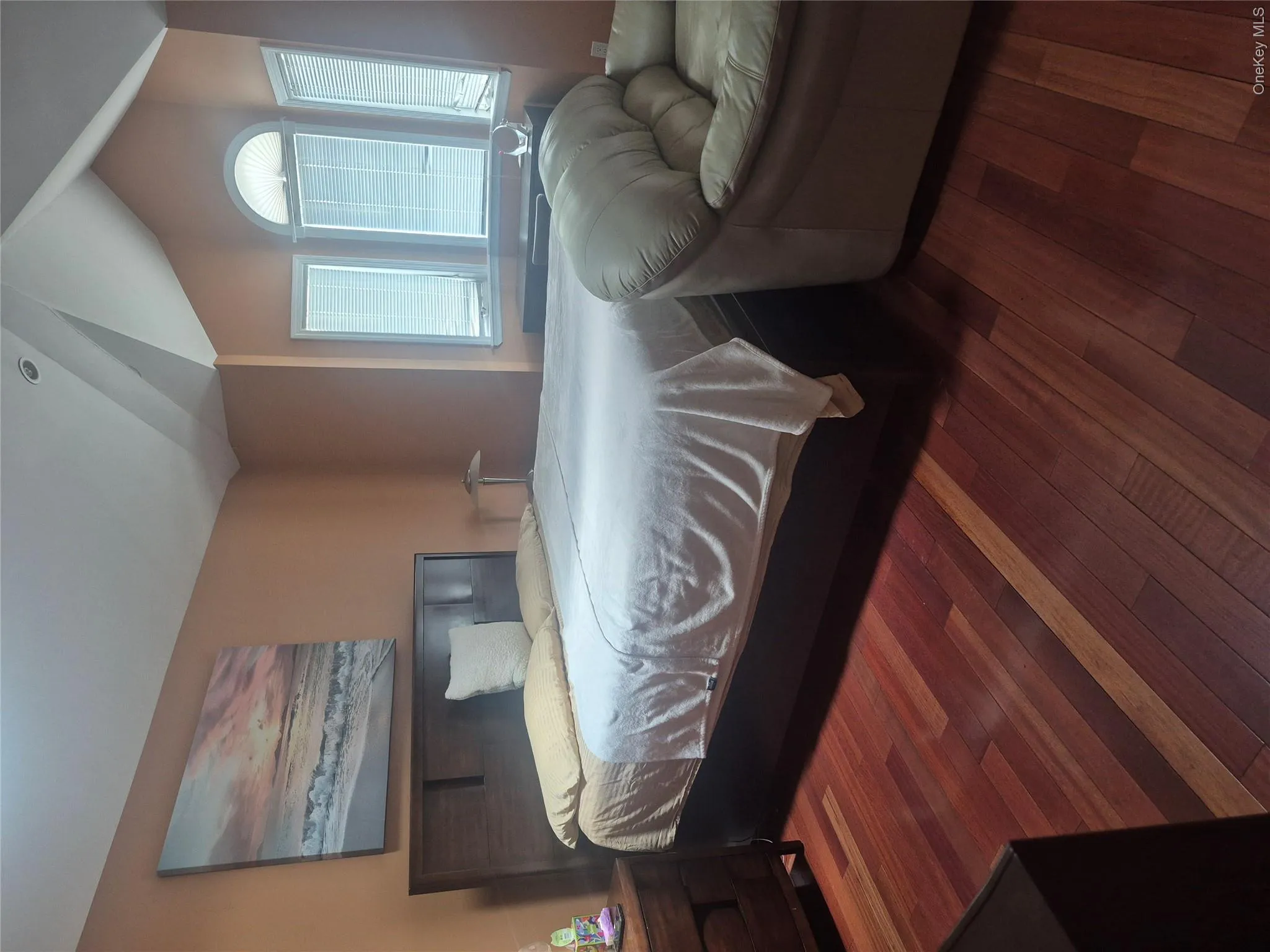 Master Bedroom with wood-finish flooring, recessed lighting, a vaulted ceiling and arched bay window Master Bedroom with wood-finish flooring, recessed lighting, a vaulted ceiling and arched bay window