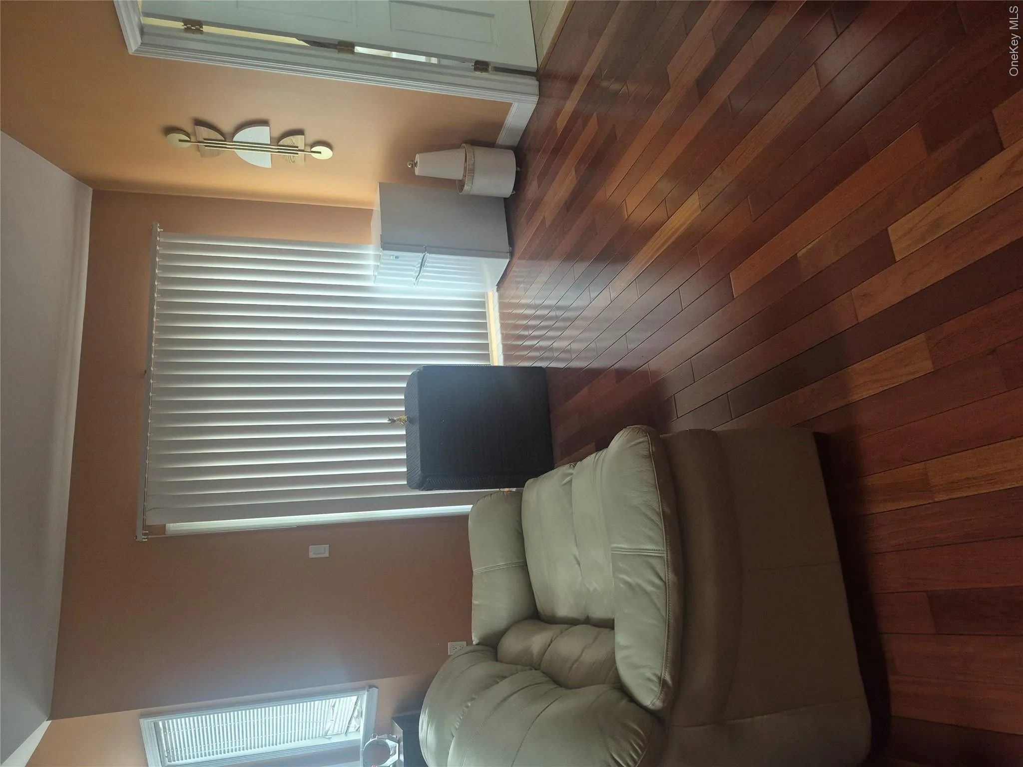 Master Bedroom with hardwood flooring throughout, vertical blinds, and an arched window with horizontal blinds Master Bedroom with hardwood flooring throughout, vertical blinds, and an arched window with horizontal blinds
