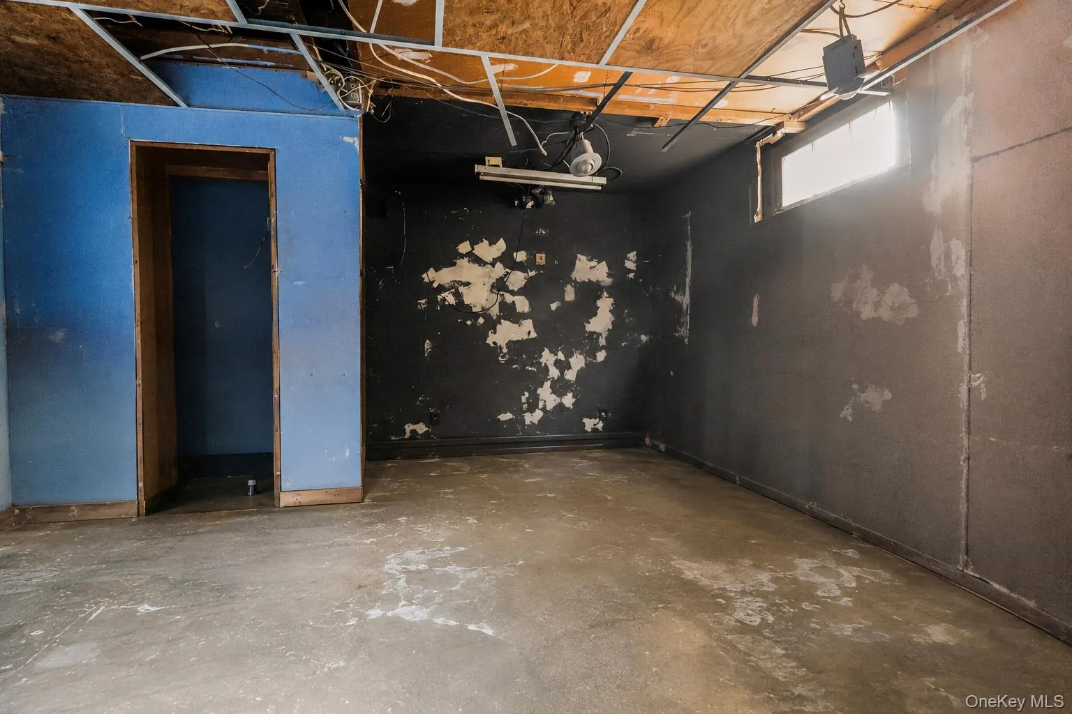 Concrete flooring, concrete perimeter walls, exposed ceiling joists, utility water heater, and a furnace system Concrete flooring, concrete perimeter walls, exposed ceiling joists, utility water heater, and a furnace system