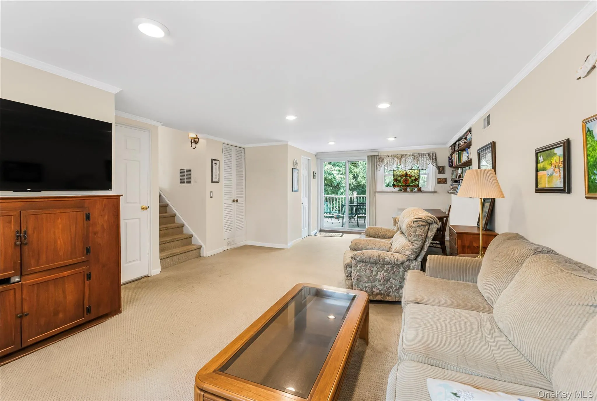 Recessed ceiling lighting, crown molding, built-in shelving, carpet flooring, and a window with natural light Recessed ceiling lighting, crown molding, built-in shelving, carpet flooring, and a window with natural light