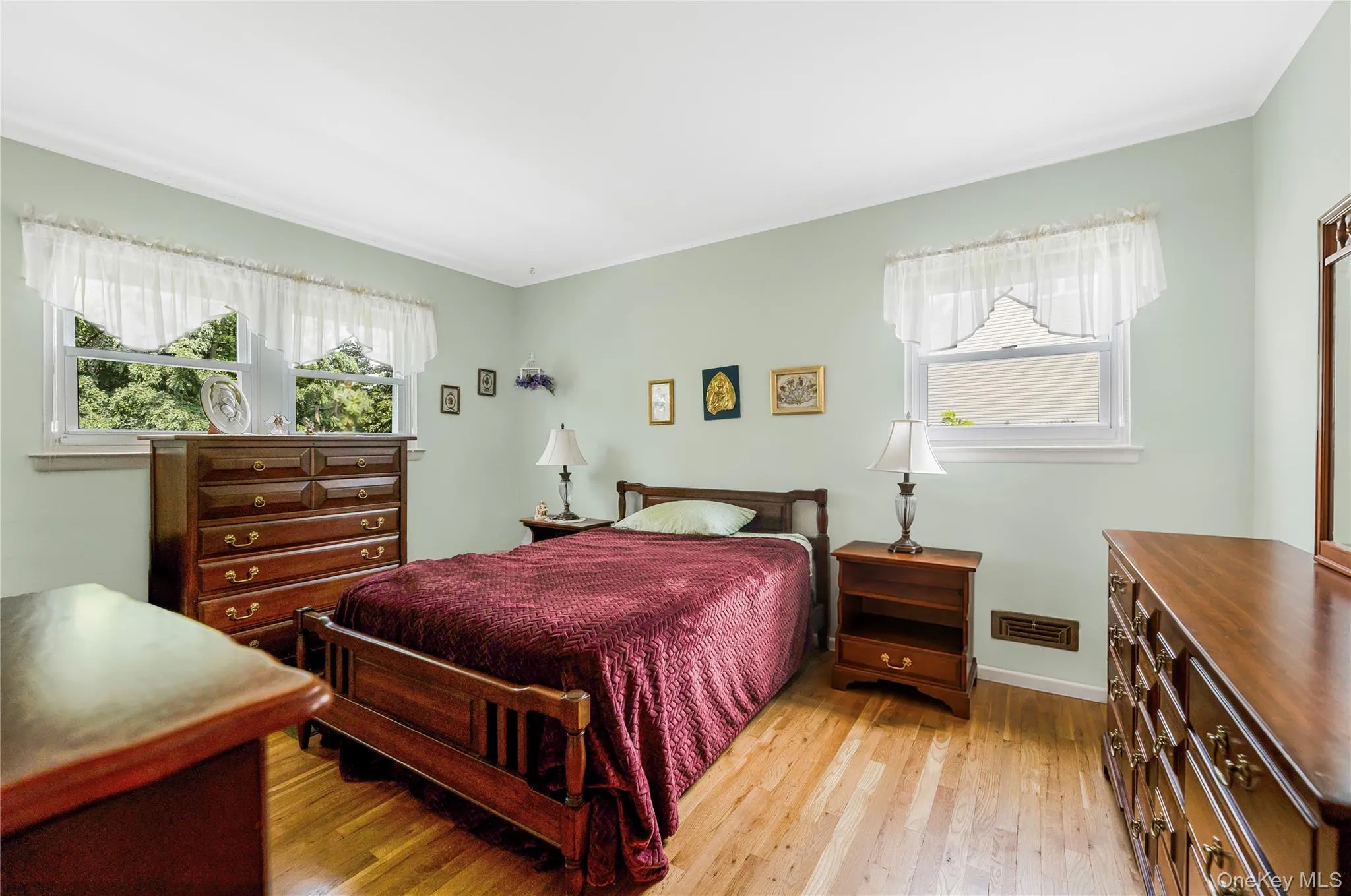 Wood-finish flooring, light-toned walls, and white trim work Wood-finish flooring, light-toned walls, and white trim work
