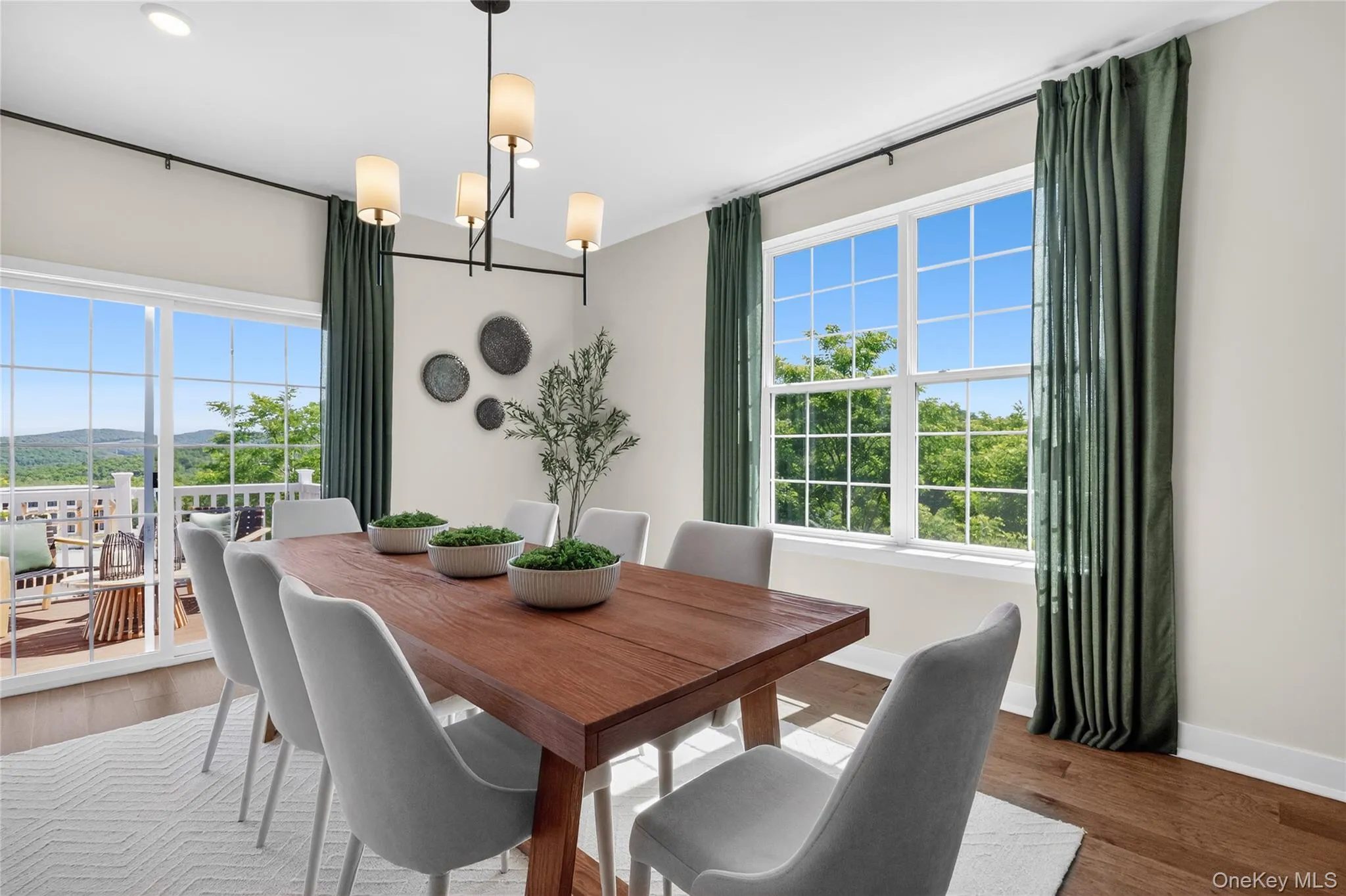 Dining area featuring a modern linear chandelier and recessed lighting. Dining area featuring a modern linear chandelier and recessed lighting.