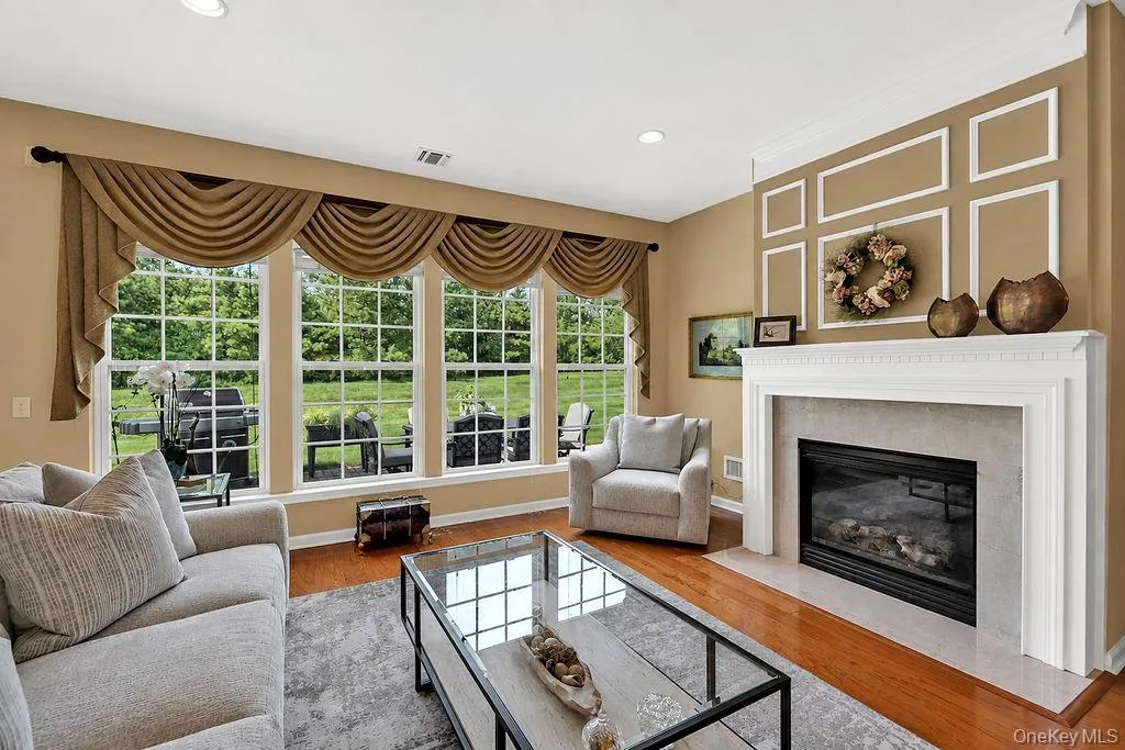 Living room with fireplace and abundant light Living room with fireplace and abundant light