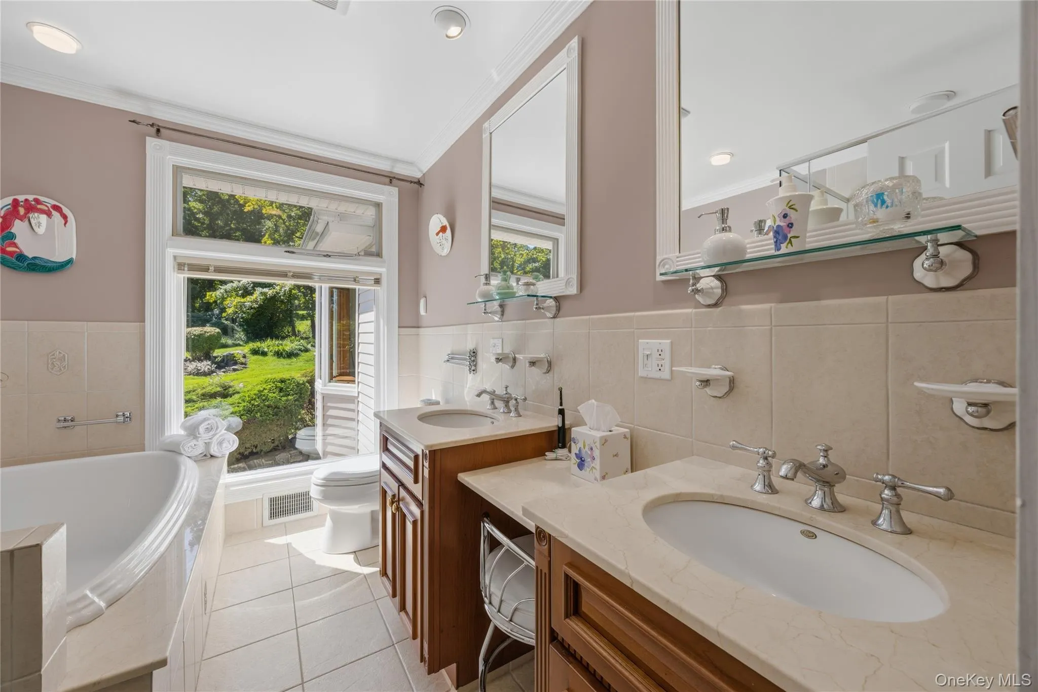 First floor primary Full Bathroom with two built-in mirrors, two sink vanities with makeup counter, Whirlpool soaking tub, & a separate walk-in shower. Nice views too First floor primary Full Bathroom with two built-in mirrors, two sink vanities with makeup counter, Whirlpool soaking tub, & a separate walk-in shower. Nice views too