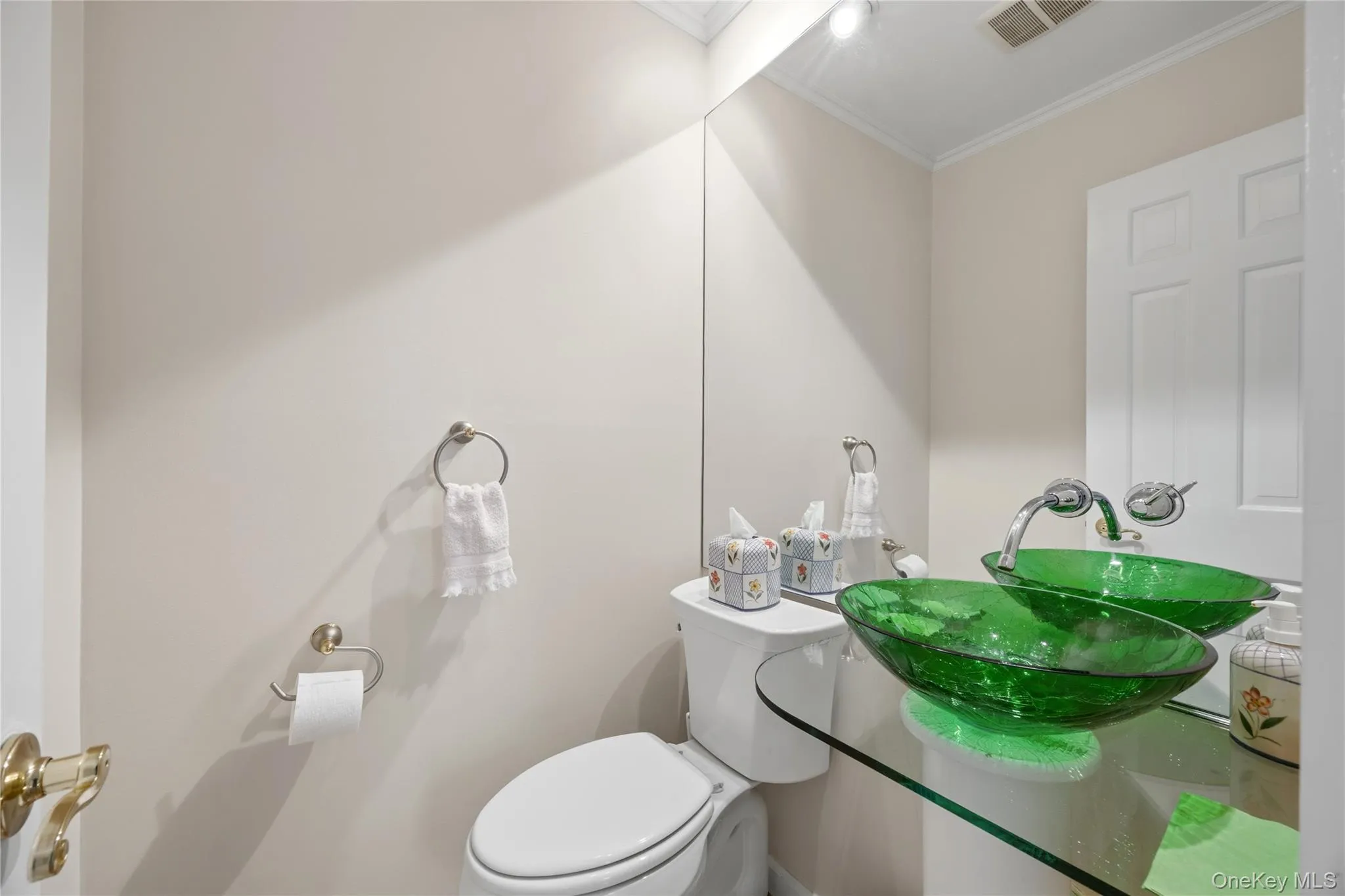 Updated Powder Room with tile floor, glass vanity with floating glass sink and wall faucet. Updated Powder Room with tile floor, glass vanity with floating glass sink and wall faucet.