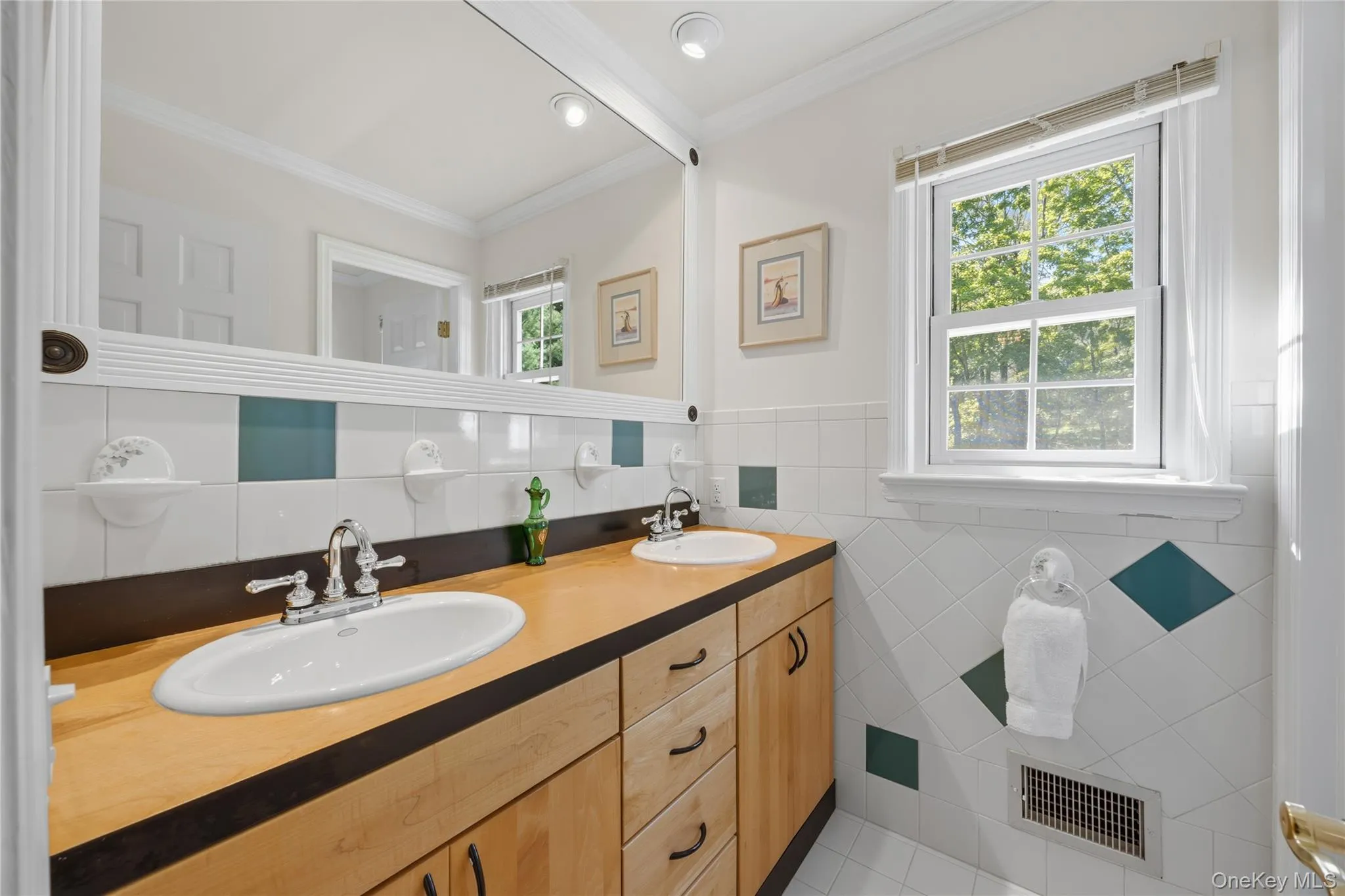 Updated Tiled Hall Bathroom with two sink vanity, built-in mirror above and a tiled Bathtub Updated Tiled Hall Bathroom with two sink vanity, built-in mirror above and a tiled Bathtub