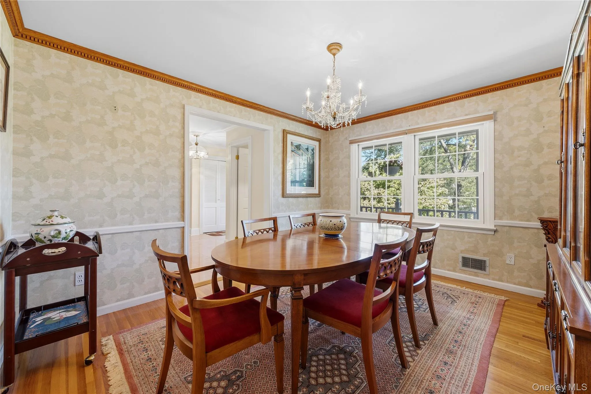 The Dining Room is spacious and provides room for the whole family! Dentil crown moldings, hardwood floors and chair rail, plus chandelier included. The Dining Room is spacious and provides room for the whole family! Dentil crown moldings, hardwood floors and chair rail, plus chandelier included.