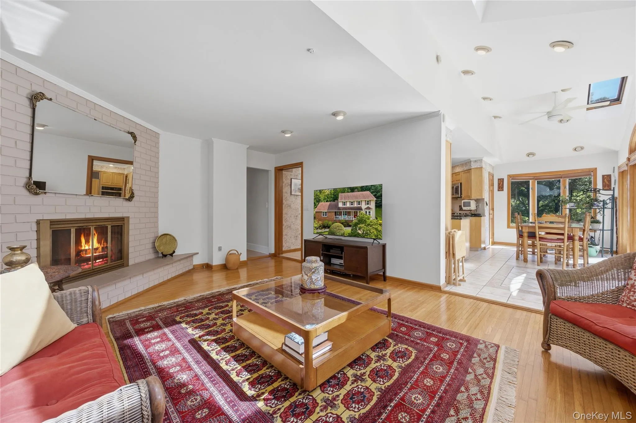 The Family Room just off the EIK offers hardwood floors, 3 skylights, partial vaulted ceiling, a wood-burning Fireplace with glass doors & brick surround The Family Room just off the EIK offers hardwood floors, 3 skylights, partial vaulted ceiling, a wood-burning Fireplace with glass doors & brick surround