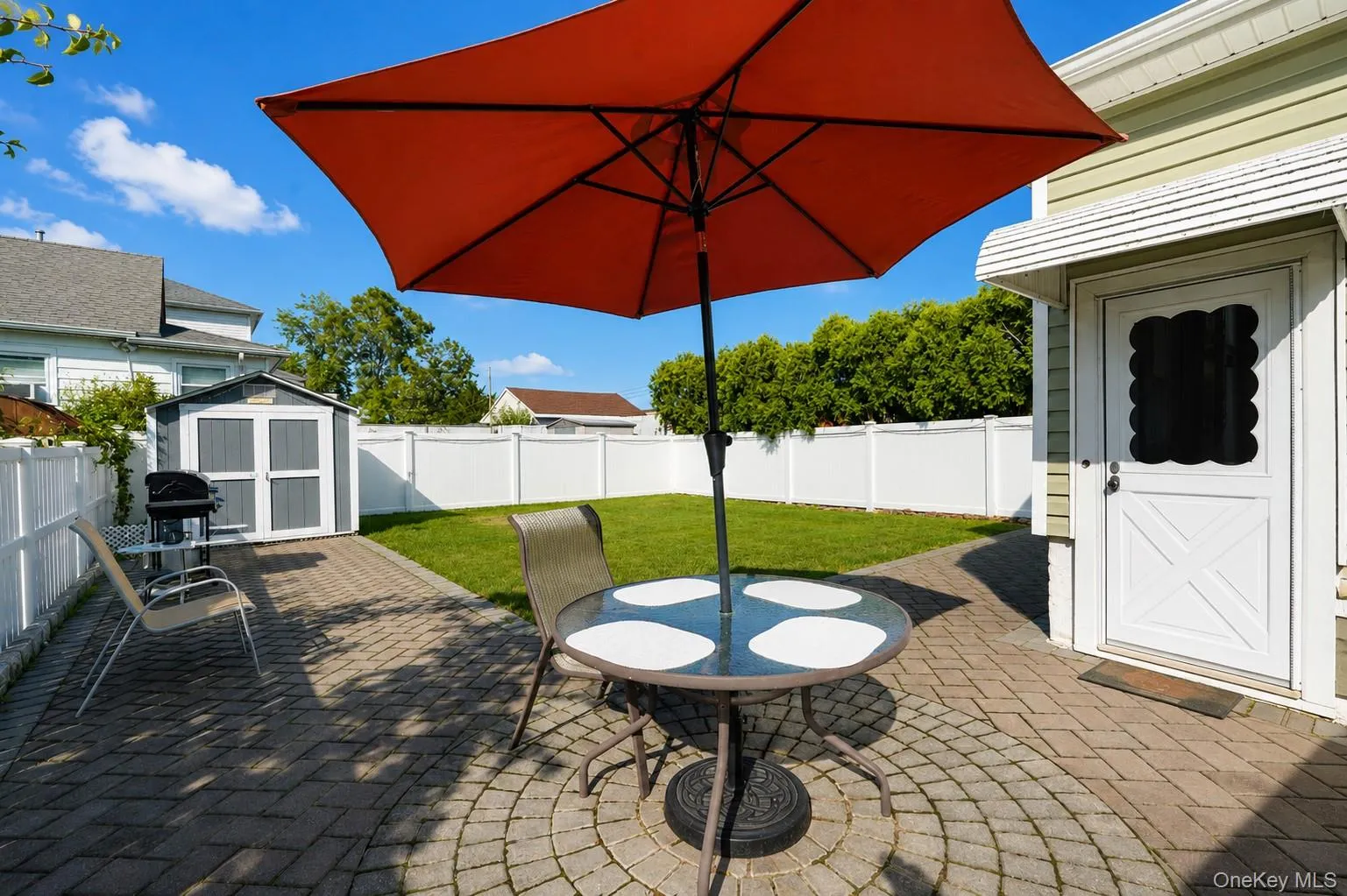 Expansive patio with permeable paver hardscaping and mature landscaping throughout the yard Expansive patio with permeable paver hardscaping and mature landscaping throughout the yard