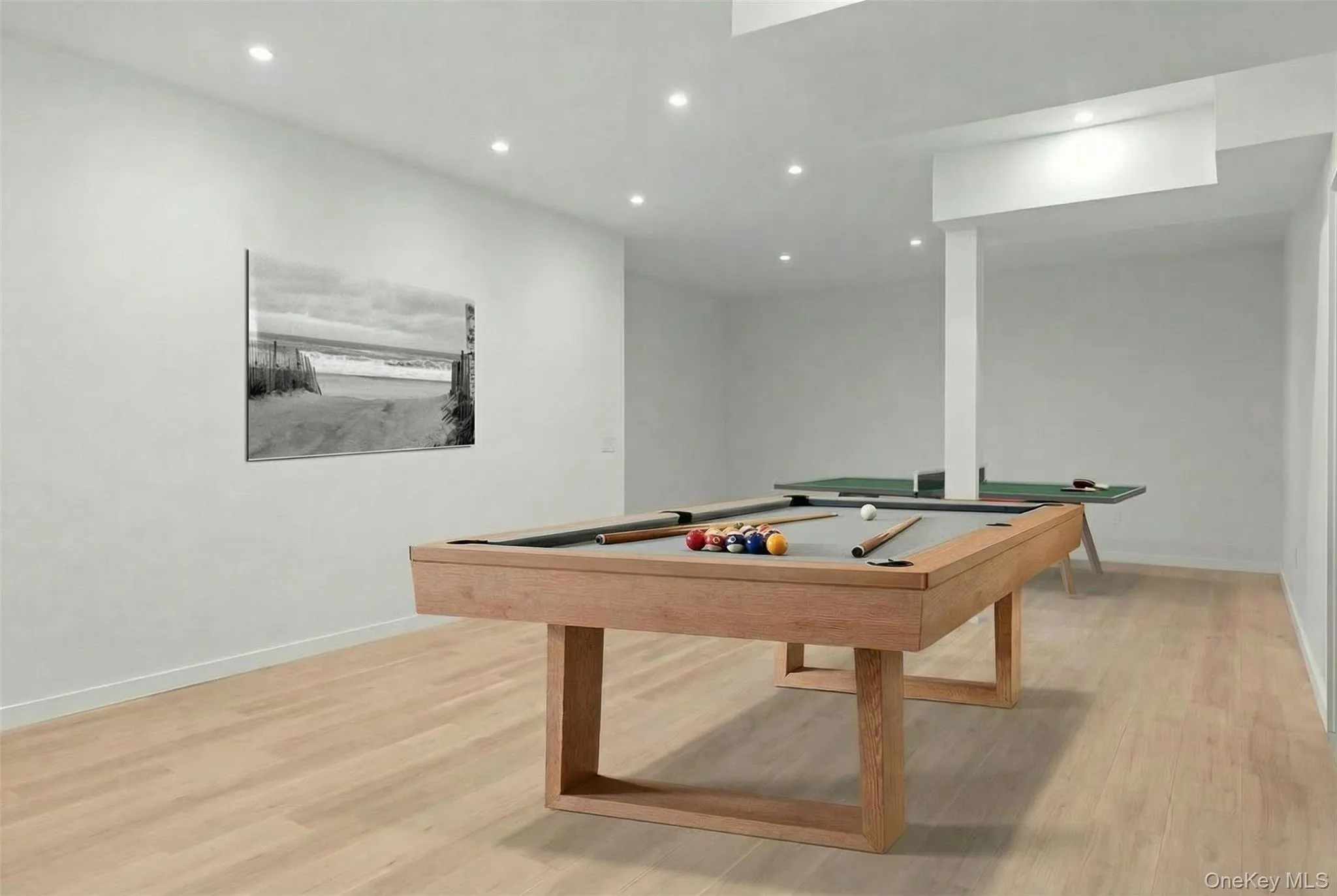 Recessed lighting throughout, light wood-finish flooring, and a structural column Recessed lighting throughout, light wood-finish flooring, and a structural column