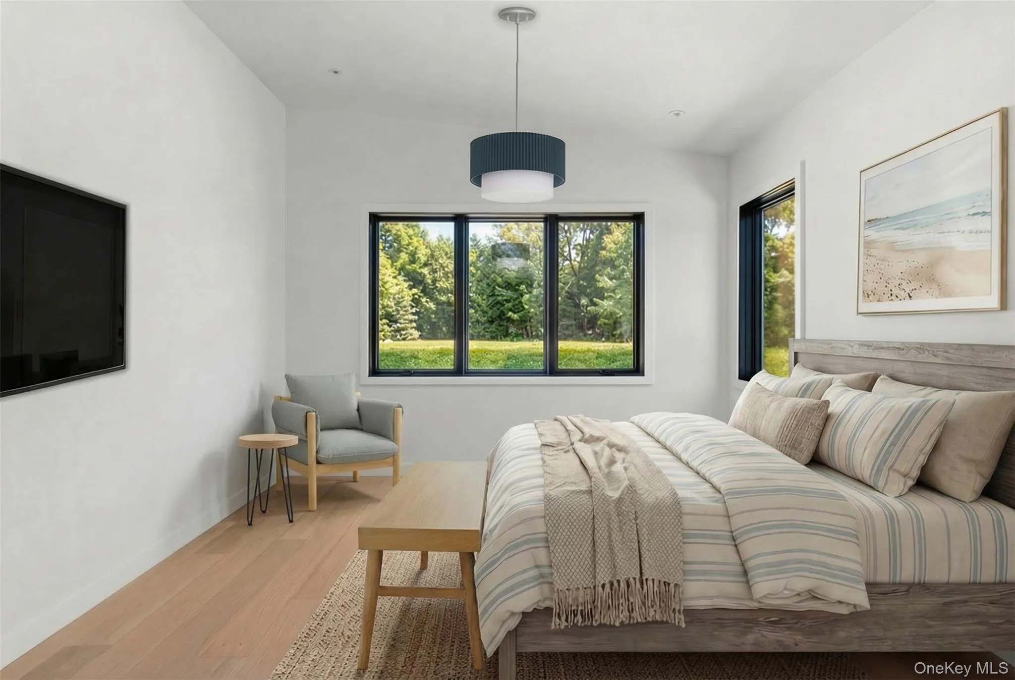 Light wood-finish flooring, white walls, and a multi-pane window with black framing Light wood-finish flooring, white walls, and a multi-pane window with black framing