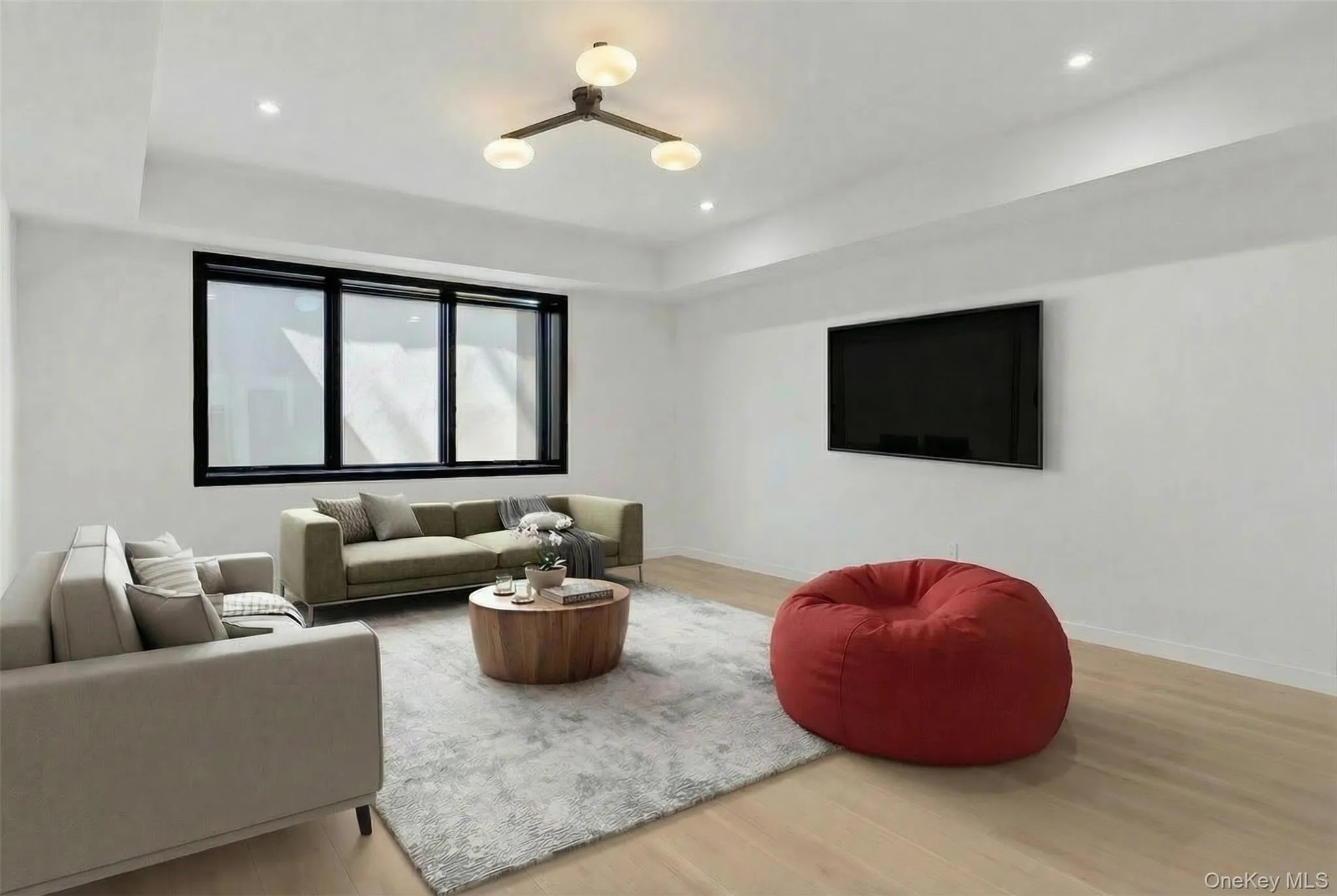 Recessed lighting, wood-finish flooring, a wall-mounted display, and a modern ceiling fixture Recessed lighting, wood-finish flooring, a wall-mounted display, and a modern ceiling fixture