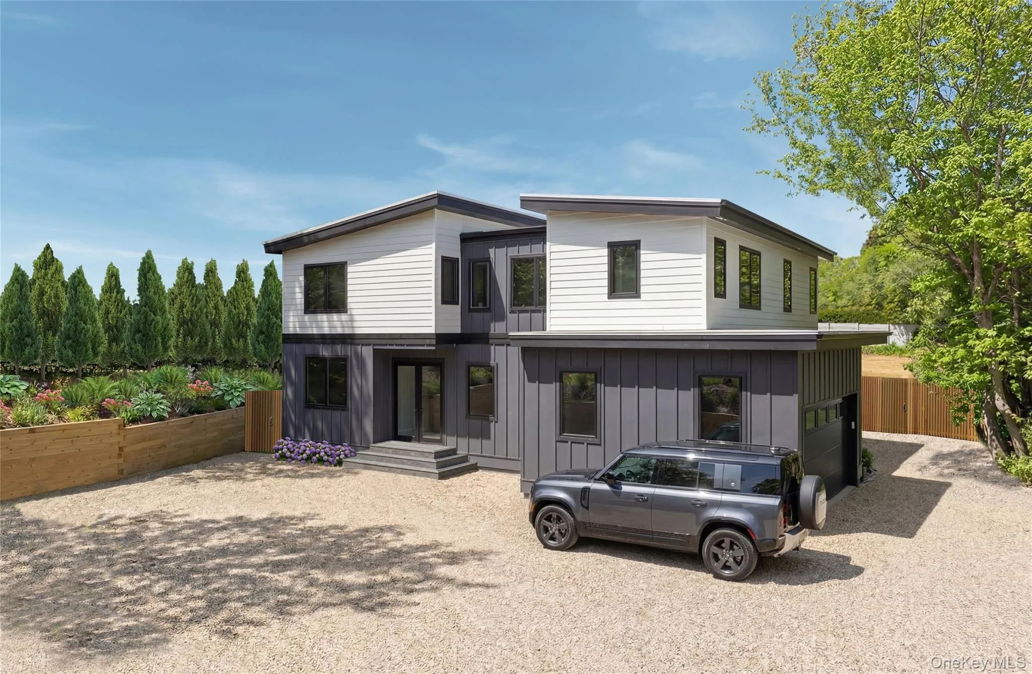 Modern two-story exterior with contrasting light /dark siding, att 3 car garage Modern two-story exterior with contrasting light /dark siding, att 3 car garage