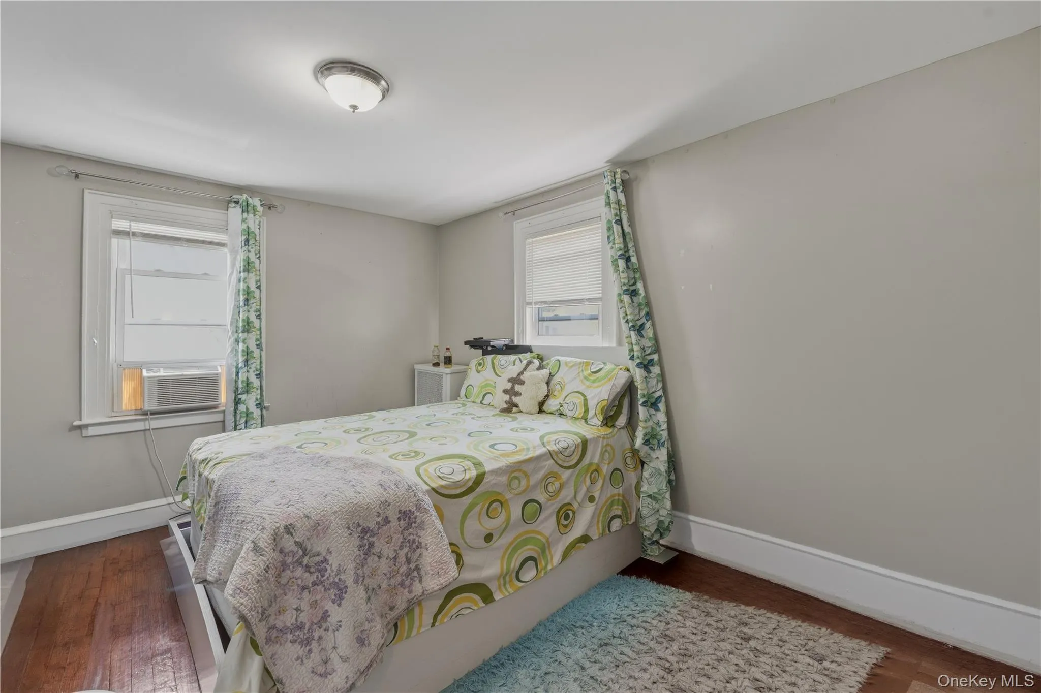 Wood-finish flooring with light-toned wall paint and white trim Wood-finish flooring with light-toned wall paint and white trim