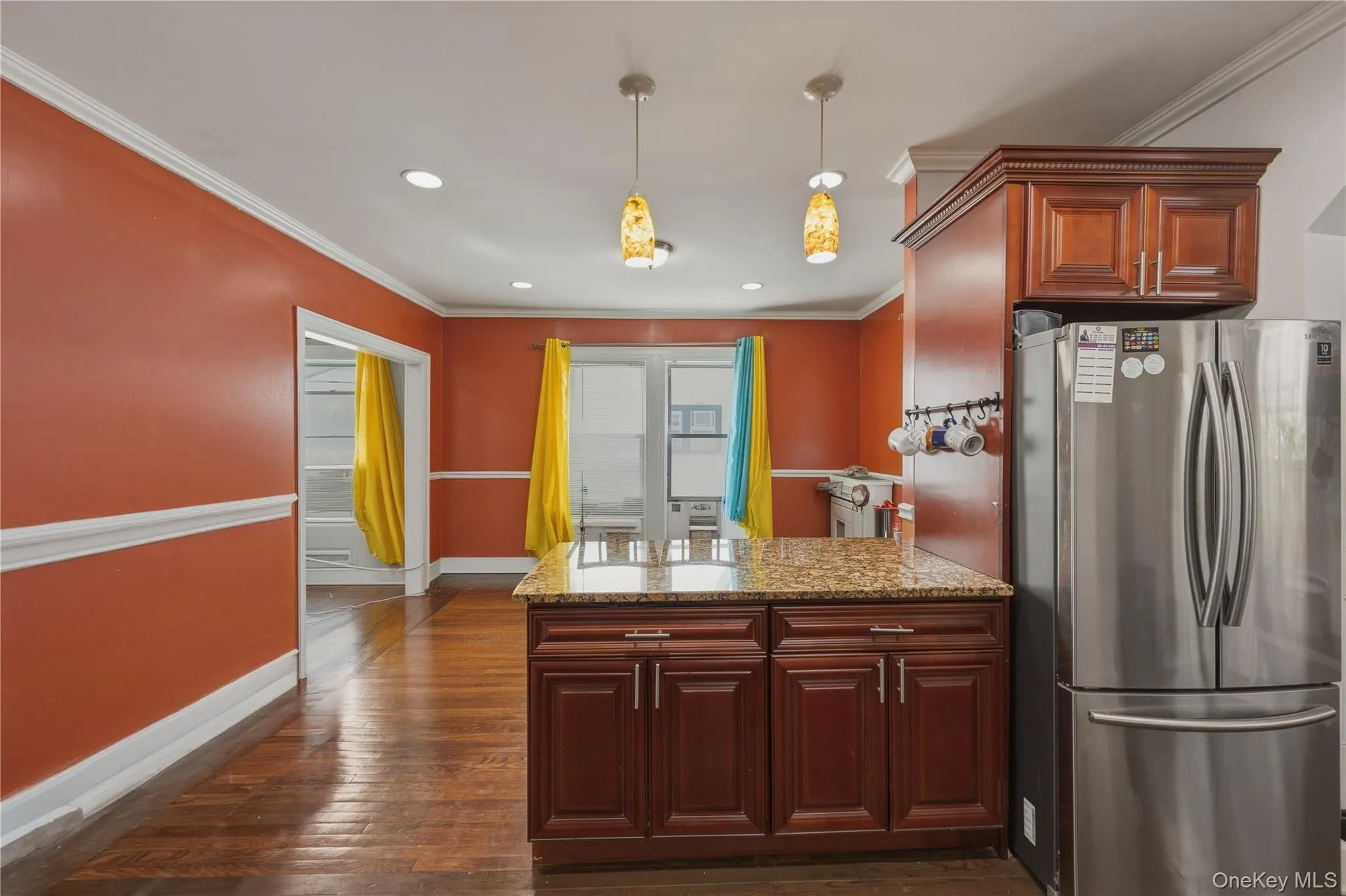 Wood-finish flooring throughout, recessed lighting, crown molding, and a kitchen island with a granite countertop Wood-finish flooring throughout, recessed lighting, crown molding, and a kitchen island with a granite countertop