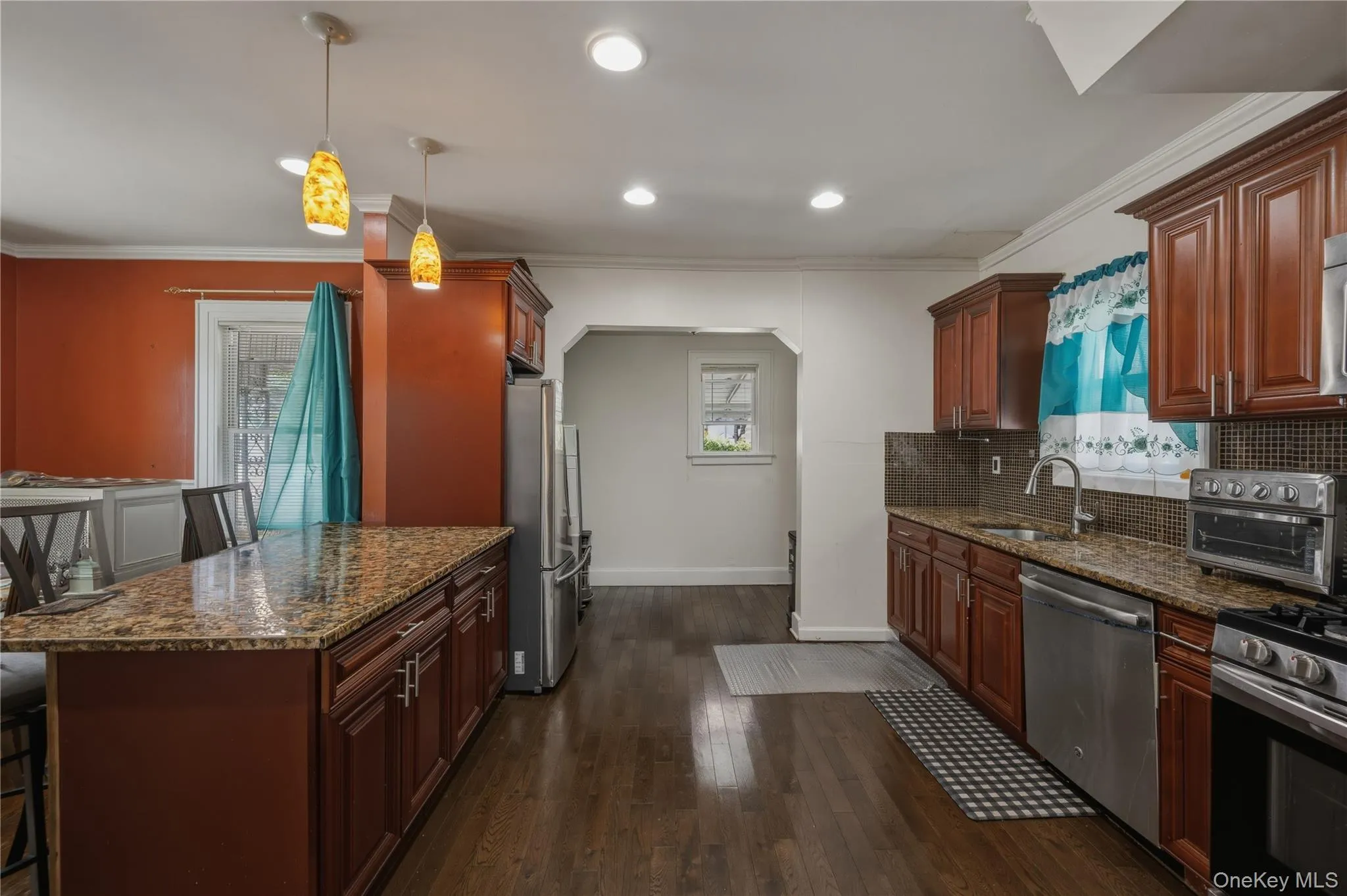 Kitchen featuring wood-finish flooring, recessed lighting, and granite countertops Kitchen featuring wood-finish flooring, recessed lighting, and granite countertops