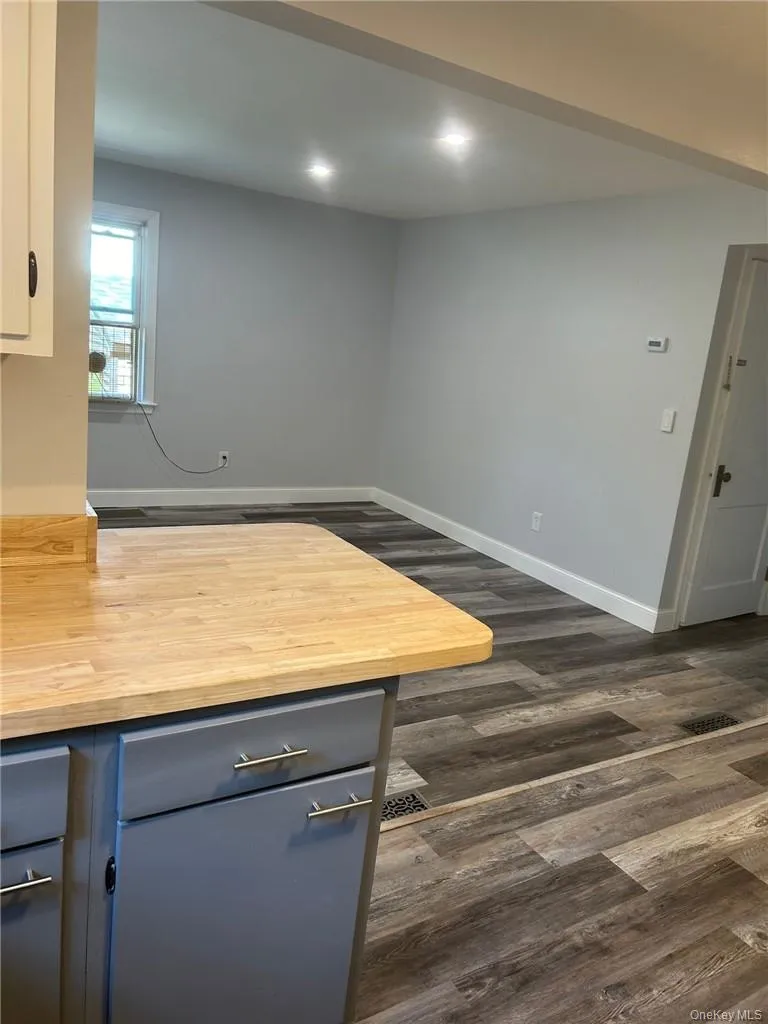 Kitchen with white cabinets, gray cabinets, and butcher block counters Kitchen with white cabinets, gray cabinets, and butcher block counters