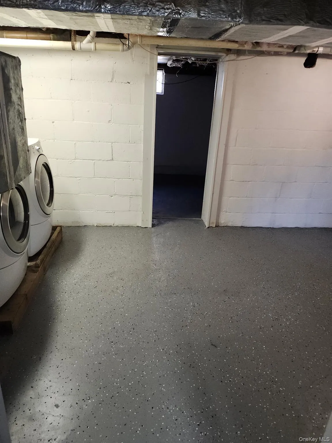 Unfinished below grade area with washer / dryer Unfinished below grade area with washer / dryer