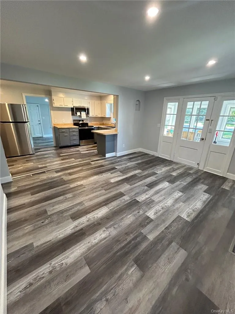Living room featuring contemporary gray flooring and Open floor plan Living room featuring contemporary gray flooring and Open floor plan