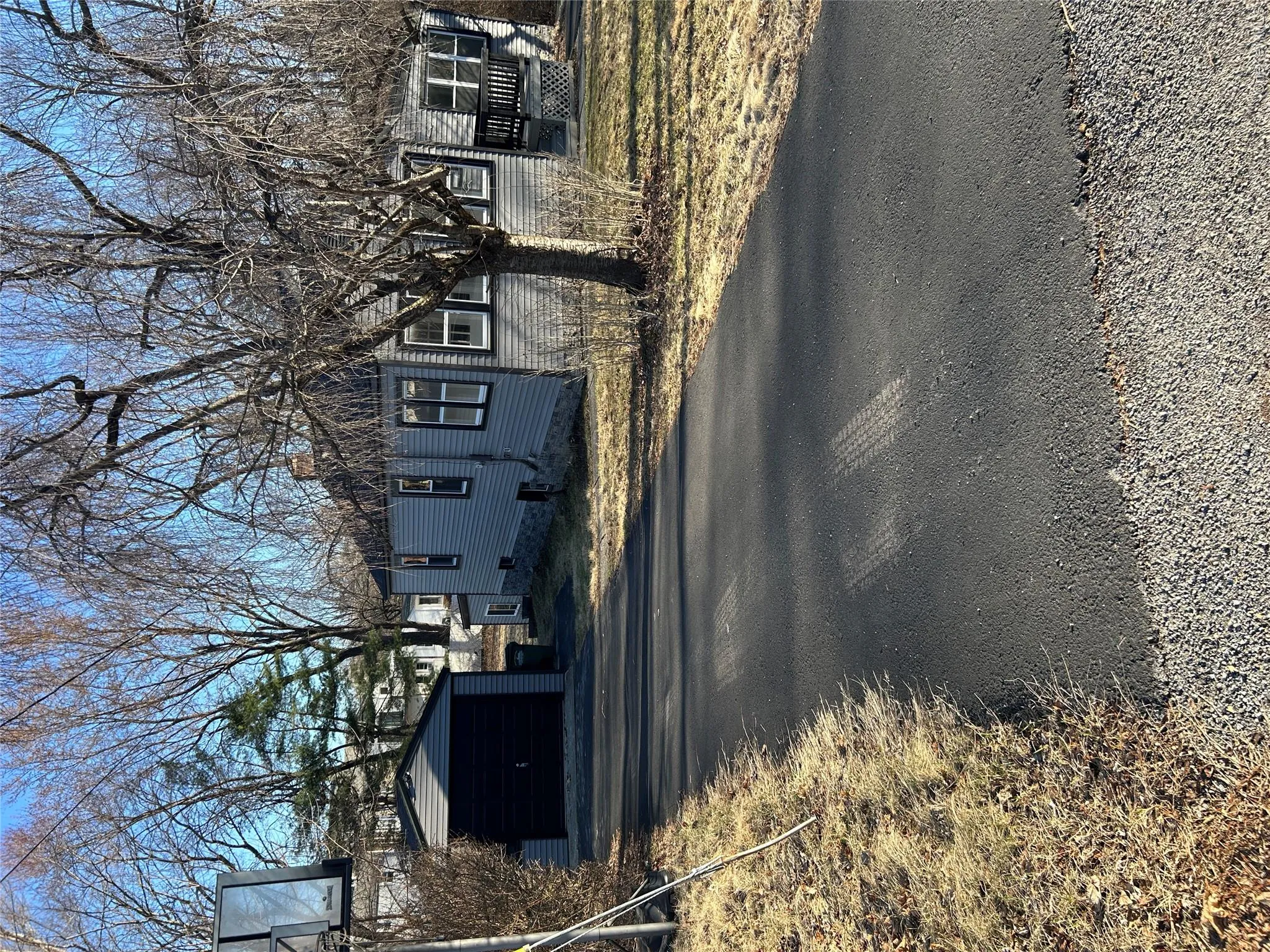 View of front of house with an outbuilding, driveway, a chimney, and a detached garage View of front of house with an outbuilding, driveway, a chimney, and a detached garage