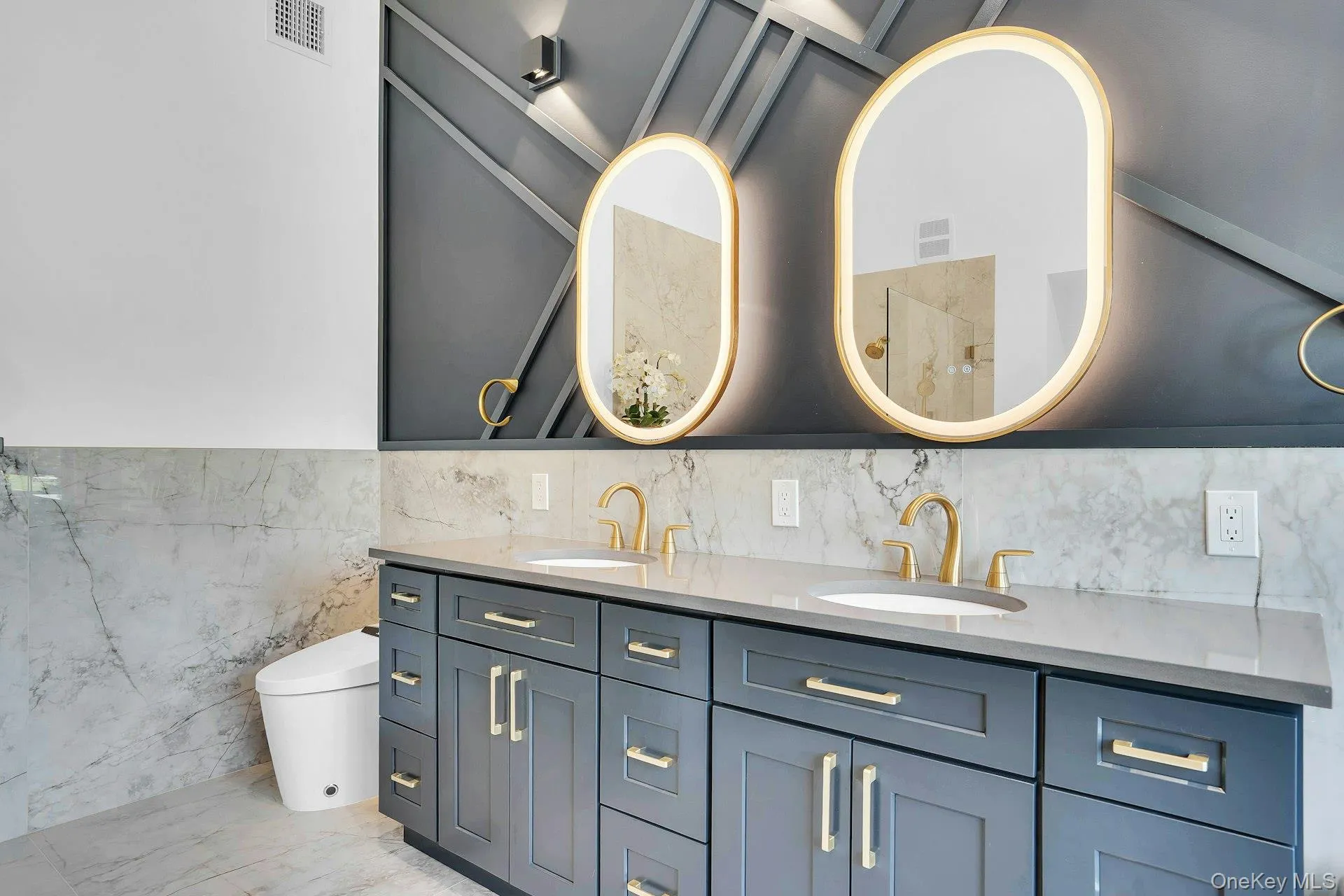 Double vanity with custom mittors and designer wainscoting. Double vanity with custom mittors and designer wainscoting.