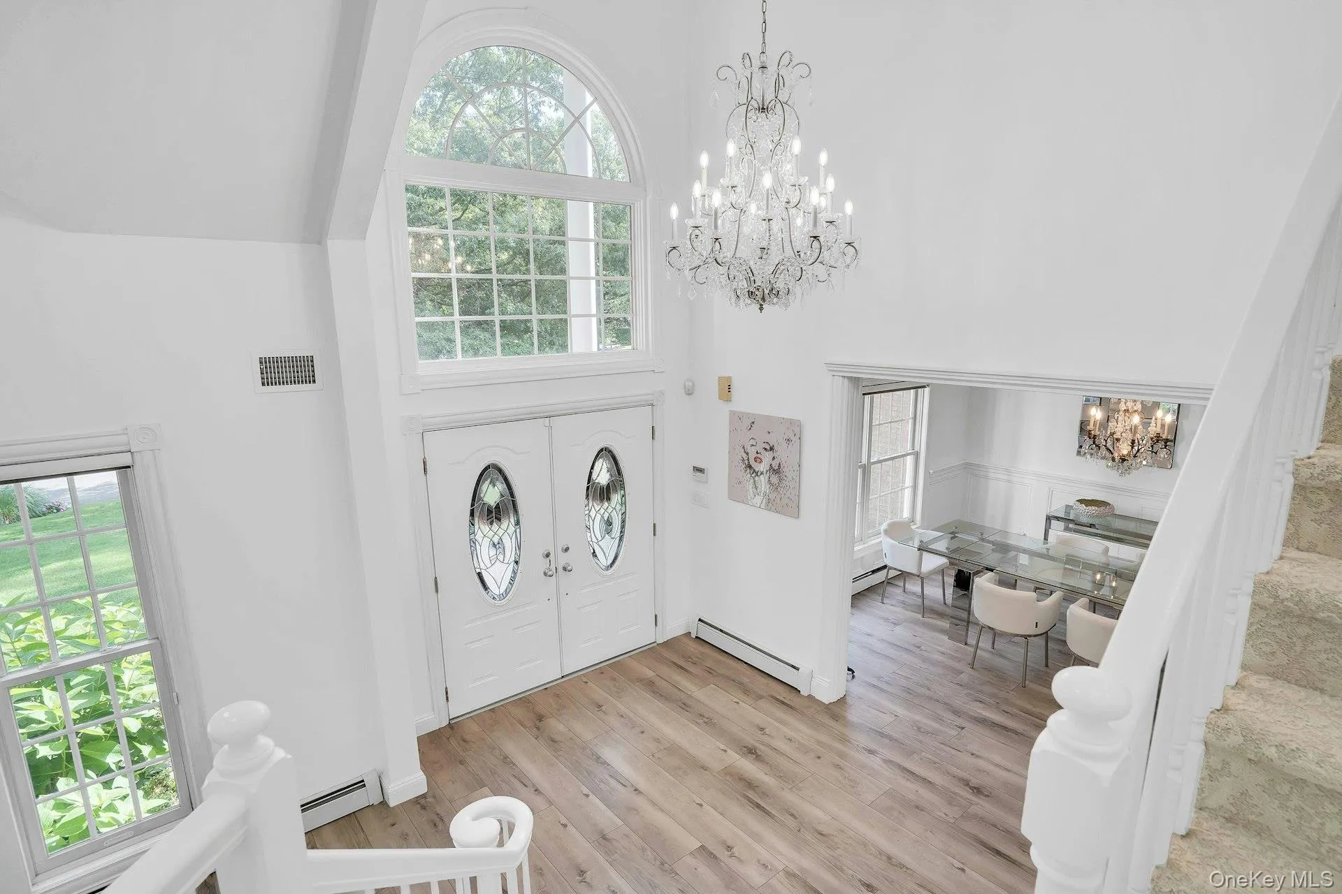Radiant chandelier highlights the foyer. Radiant chandelier highlights the foyer.
