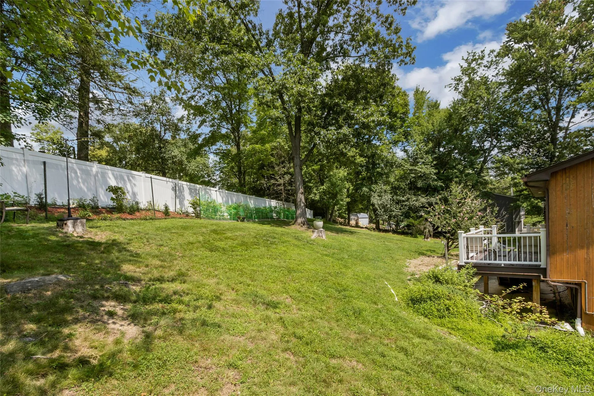 Rear of property showing fence, deck, and lots of room Rear of property showing fence, deck, and lots of room