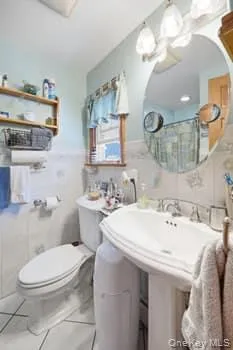 bathroom off of primary bedroom, completely tiled. bathroom off of primary bedroom, completely tiled.
