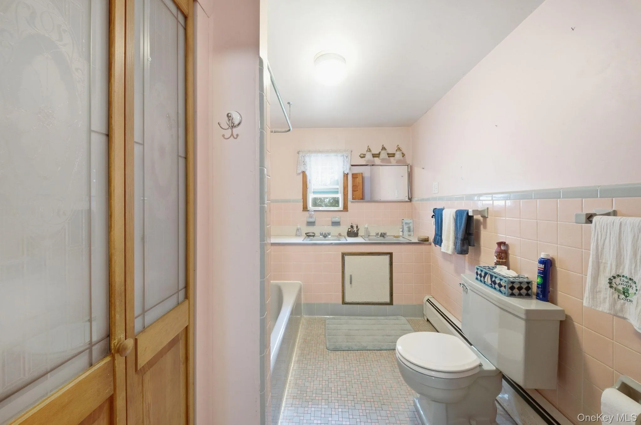 Roomy full bath on bedroom level, mostly tiled with mid-century motif. Roomy full bath on bedroom level, mostly tiled with mid-century motif.