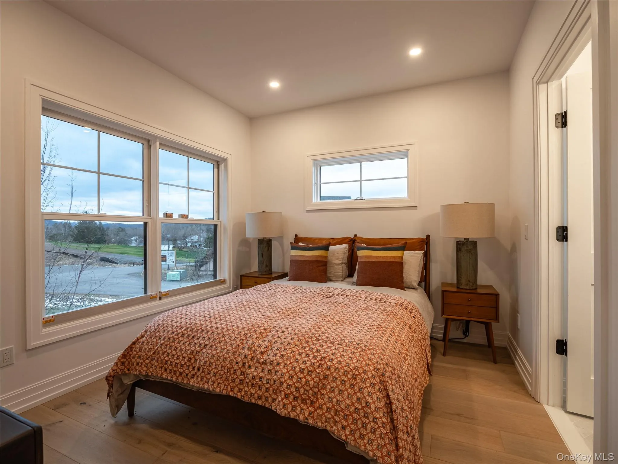 Bedroom featuring wood-type flooring and recessed lighting Bedroom featuring wood-type flooring and recessed lighting