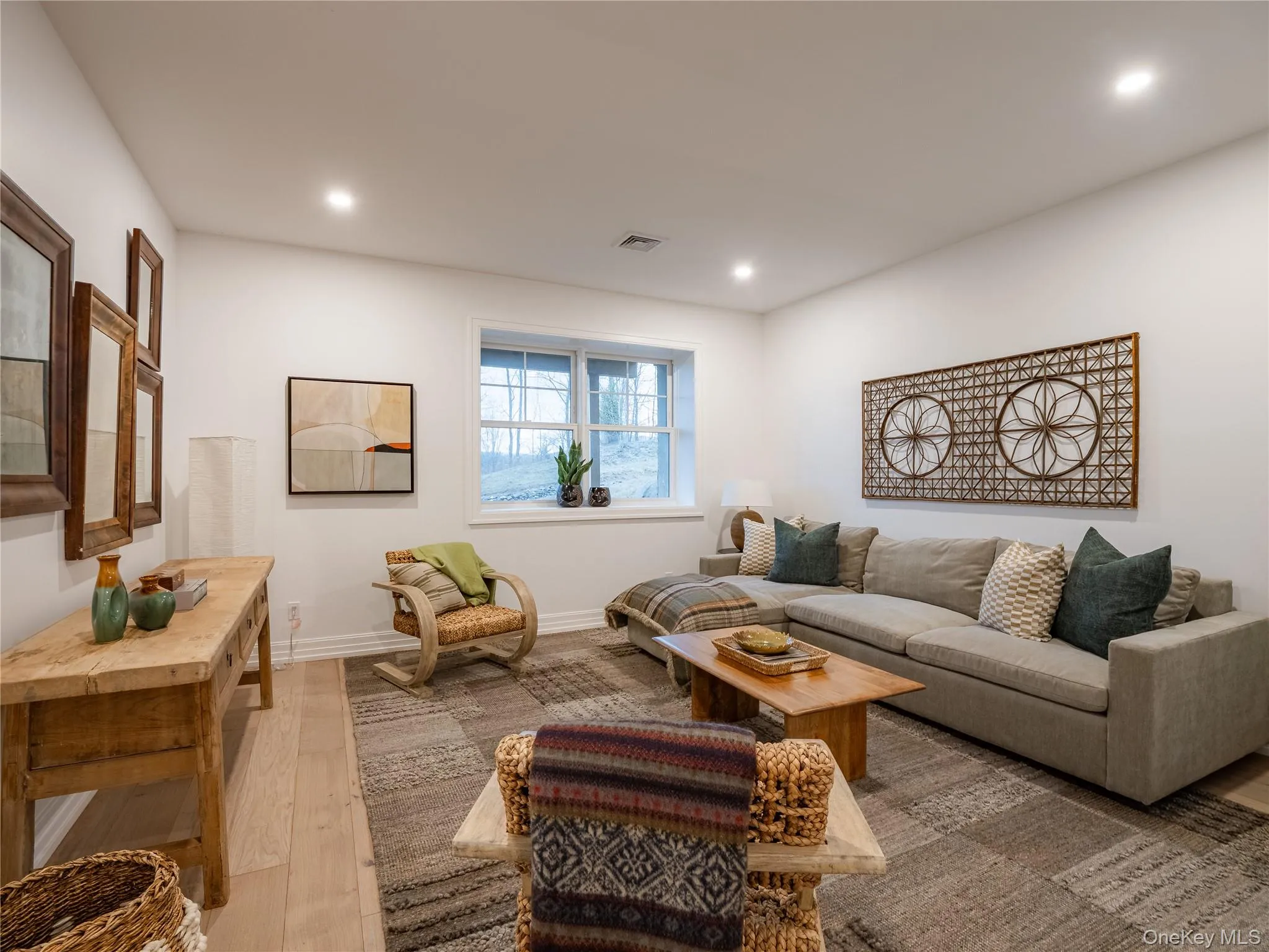 Living room featuring wood finished floors and recessed lighting Living room featuring wood finished floors and recessed lighting