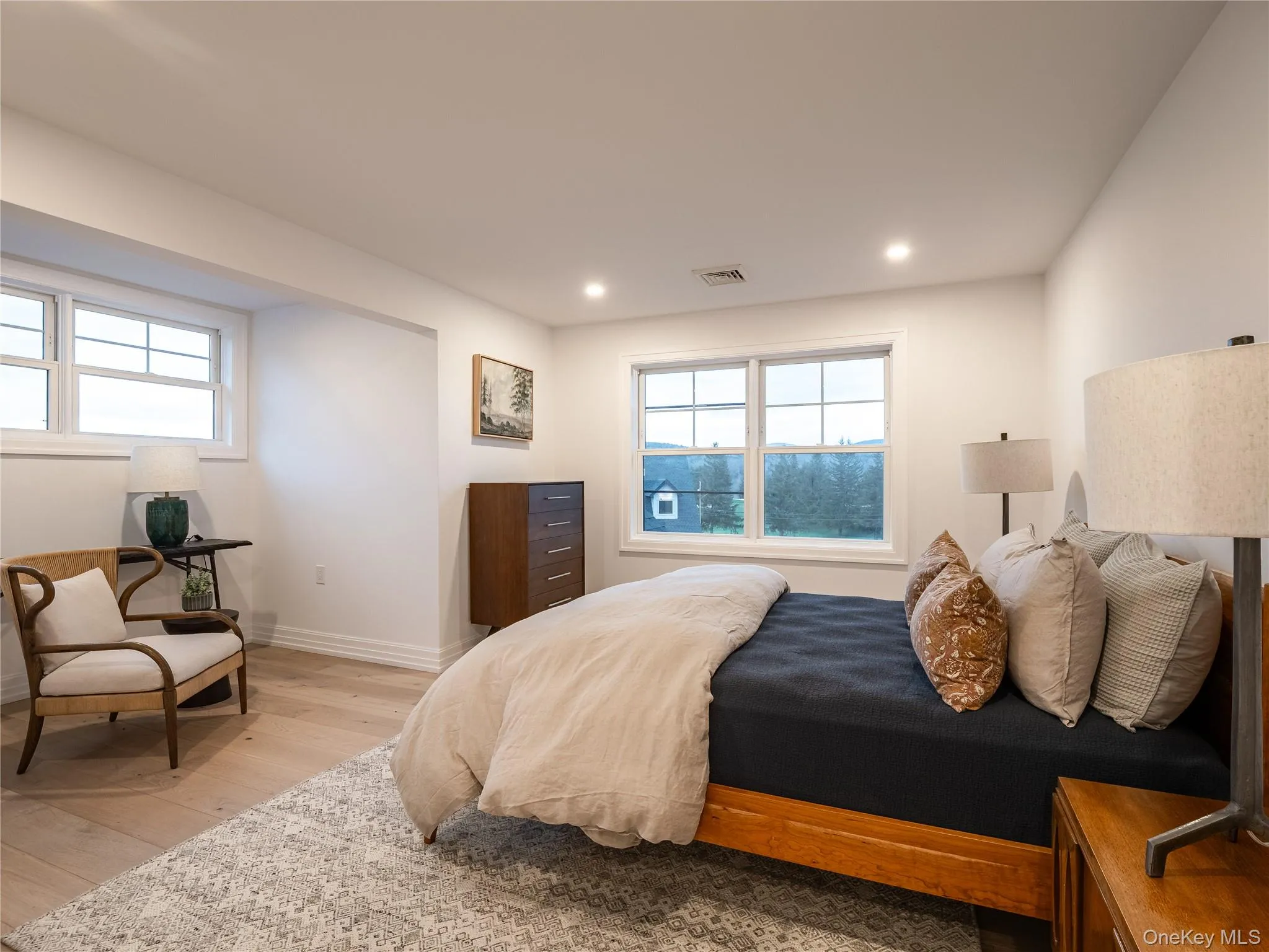 Bedroom featuring multiple windows, hardwood / wood-style flooring, and recessed lighting Bedroom featuring multiple windows, hardwood / wood-style flooring, and recessed lighting