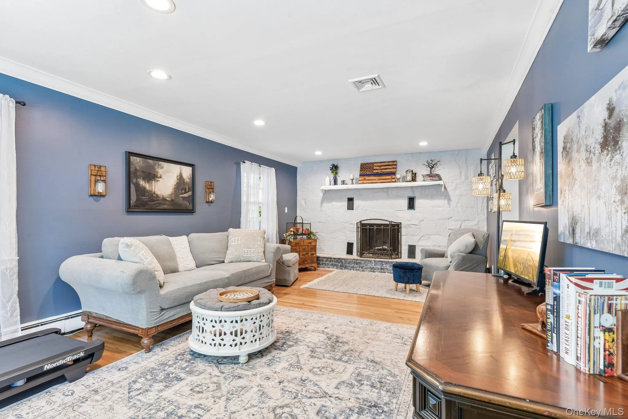 Large Living room with wood burning fireplace, and crown molding Large Living room with wood burning fireplace, and crown molding