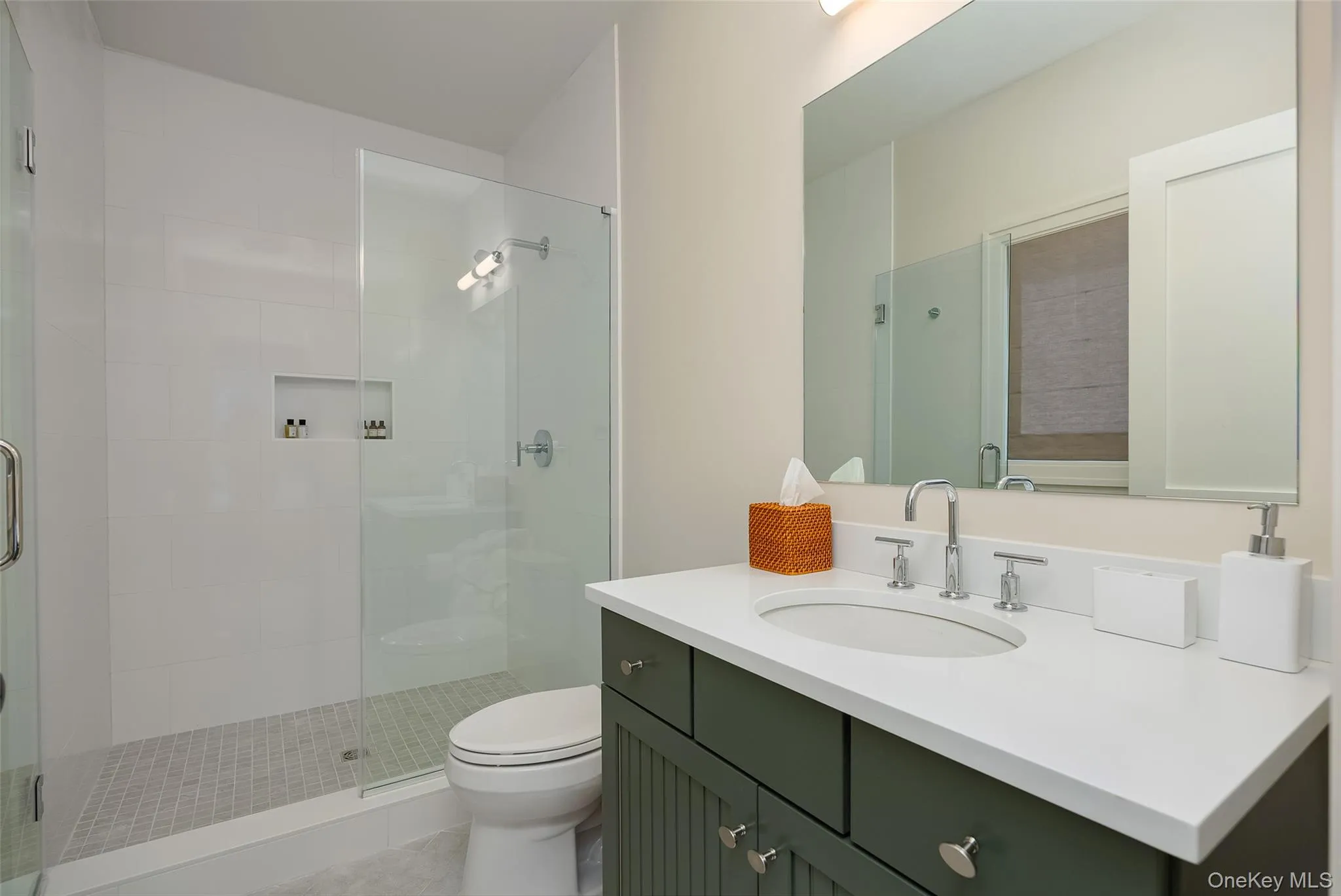 Full bath featuring vanity, a stall shower, and light tile patterned floors Full bath featuring vanity, a stall shower, and light tile patterned floors